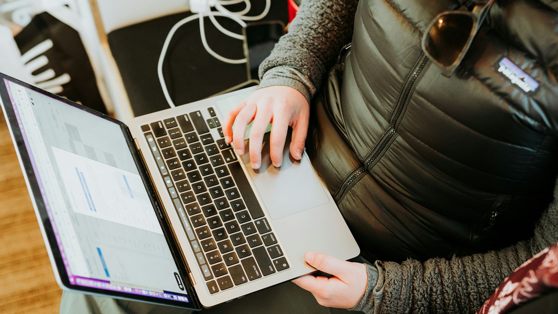 a woman sitting in front of a laptop computer