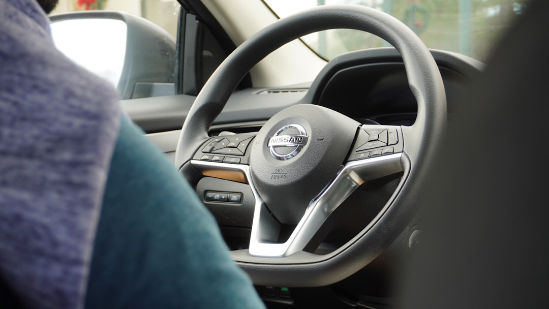a steering wheel of a car with a blue blanket