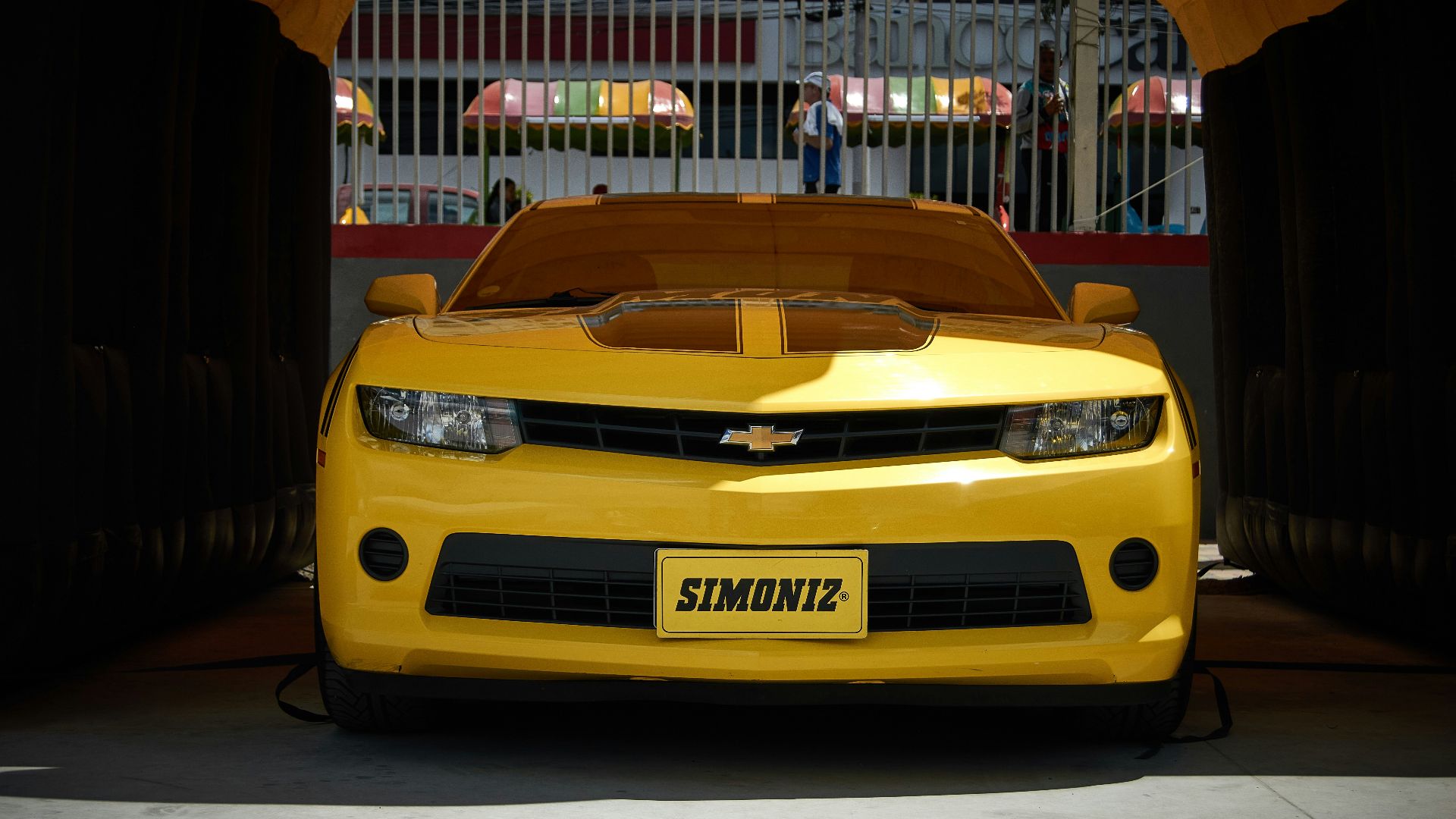 A yellow car is parked in a tunnel