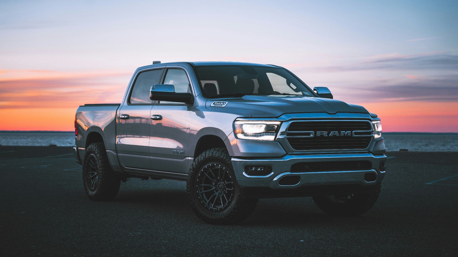 a silver ram truck parked in a parking lot
