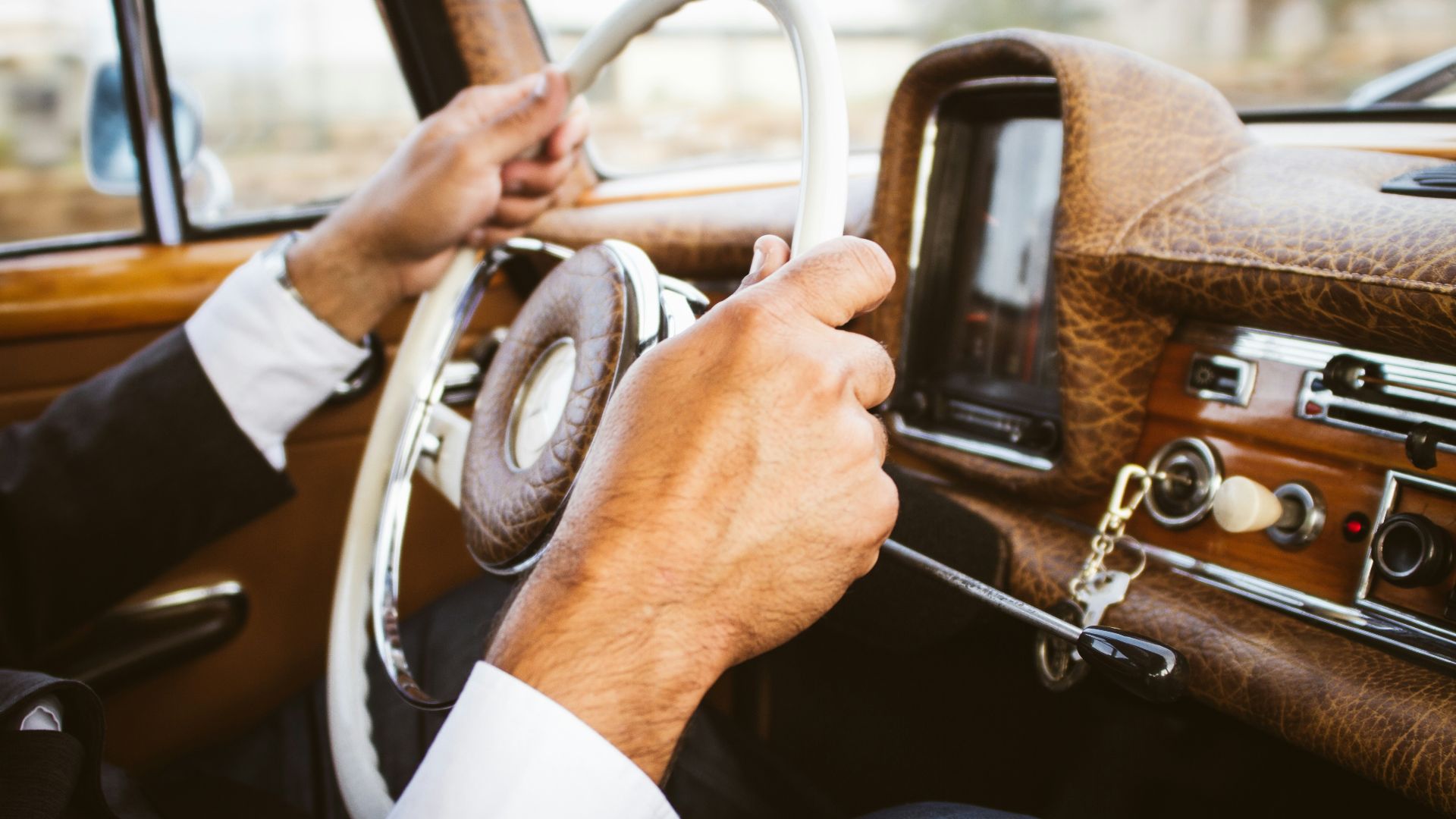 person holding vehicle steering wheel
