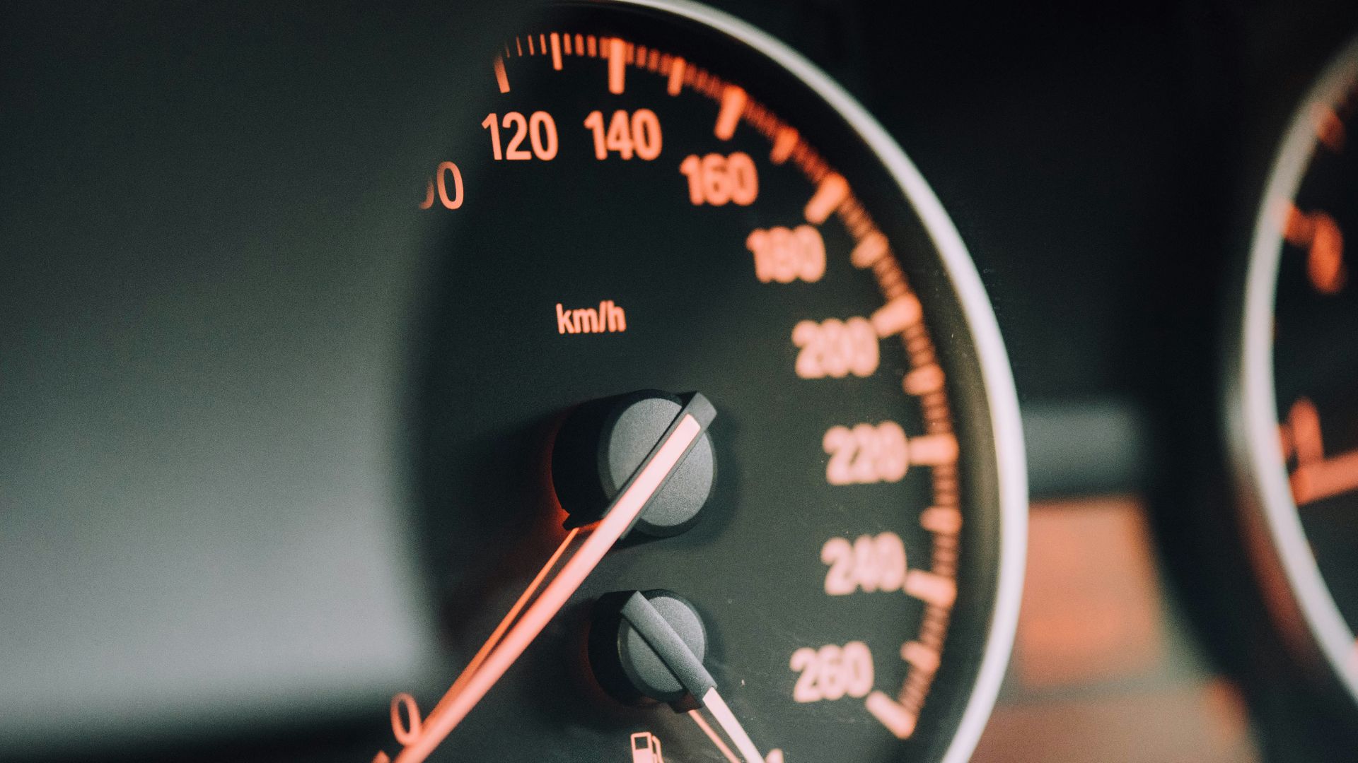 closeup photo of black analog speedometer