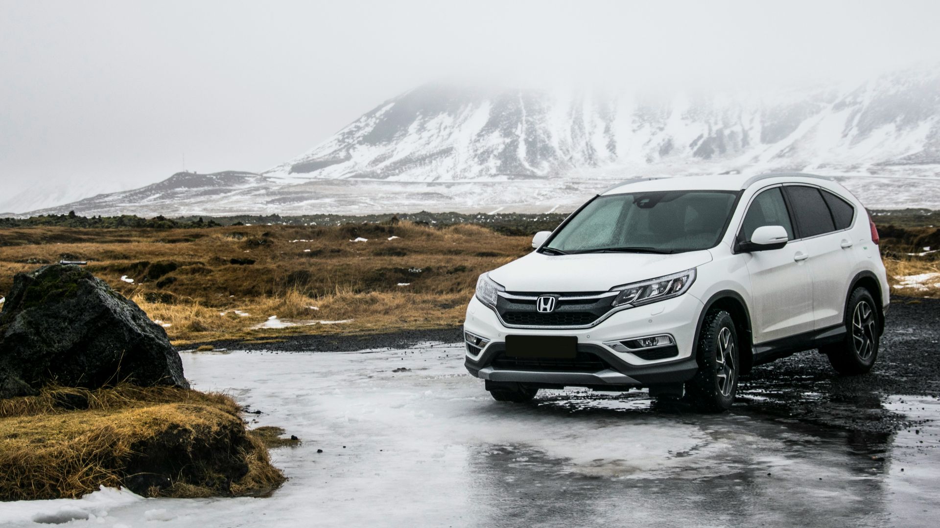 white Honda SUV on gray floor