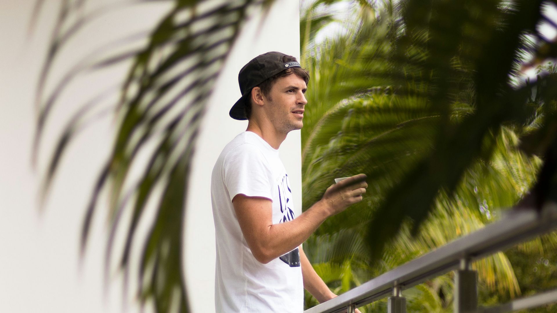 man standing near gray steel fence