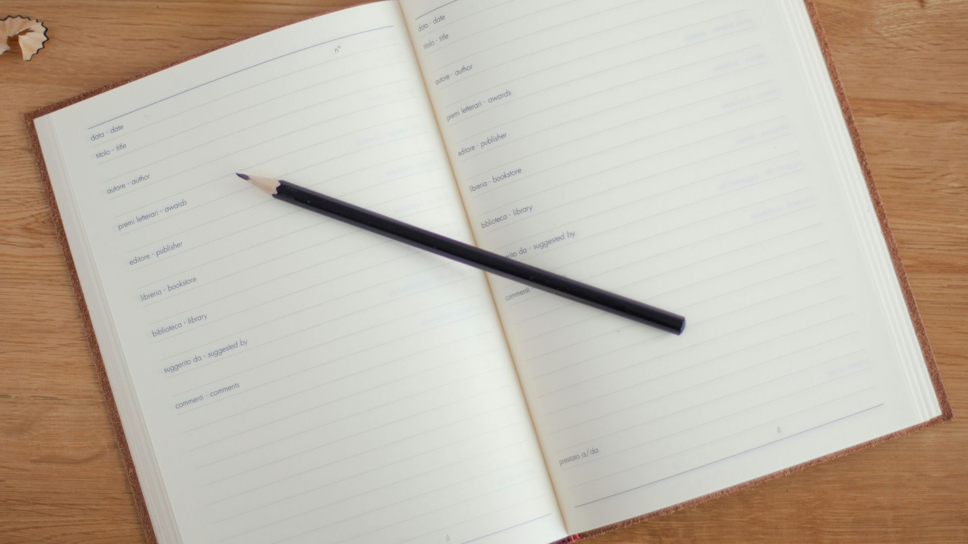 black pencil on top of ruled paper