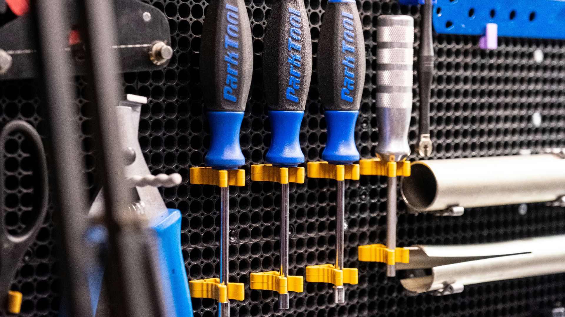 a bunch of tools hanging on a wall