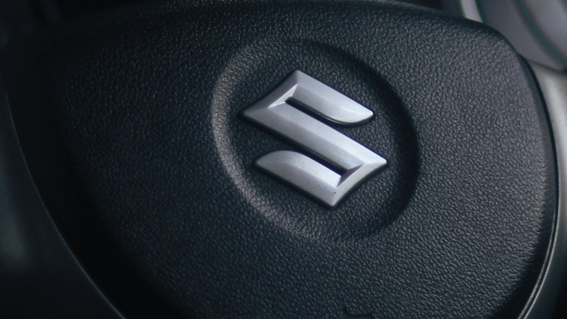 a steering wheel of a car in the rain