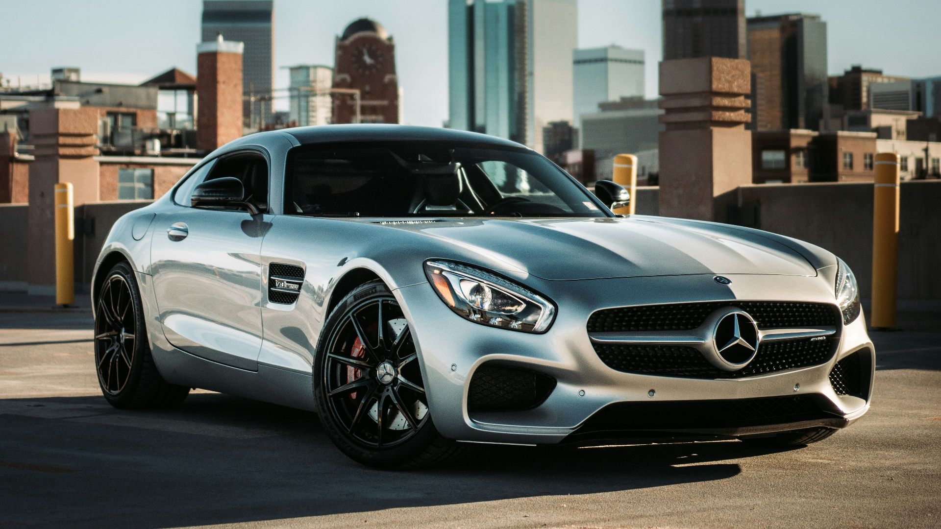 silver mercedes benz coupe parked on gray concrete road during daytime