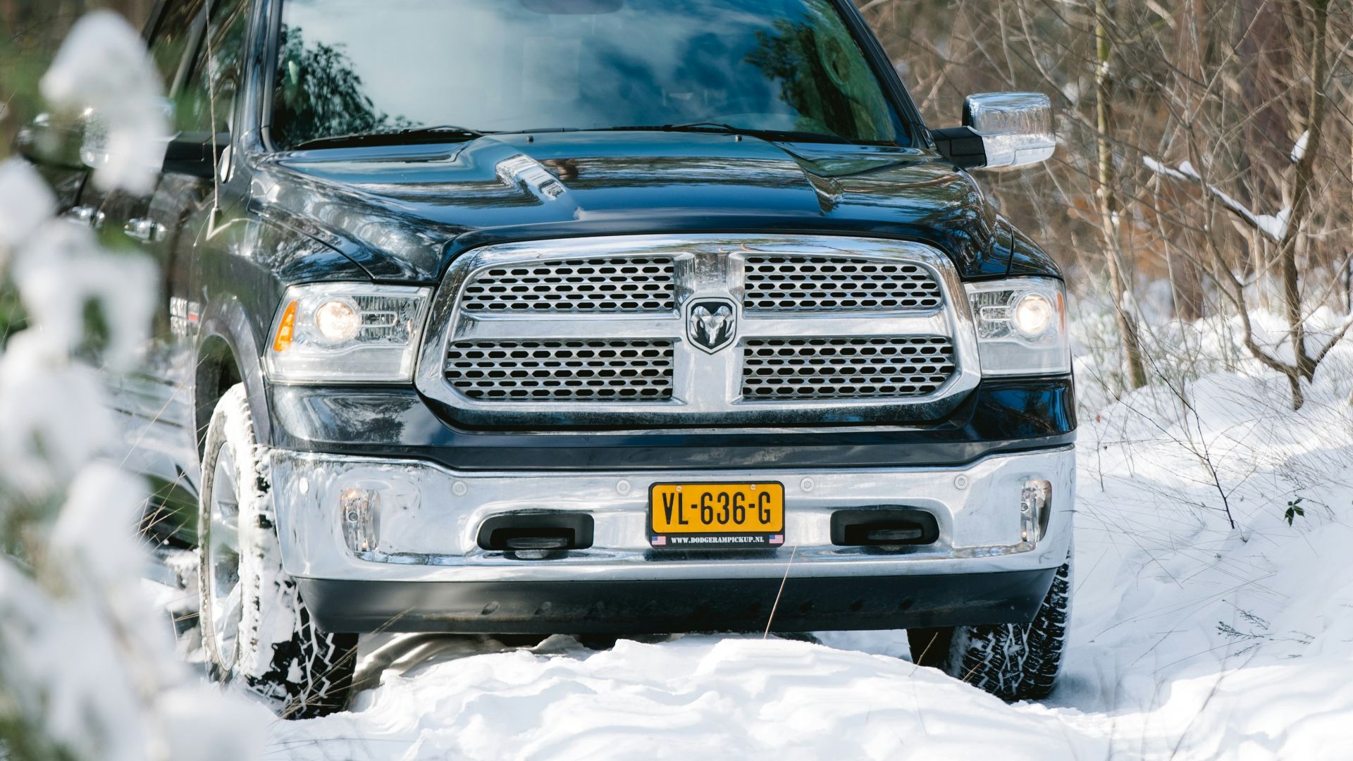 black chevrolet car on snow covered ground during daytime