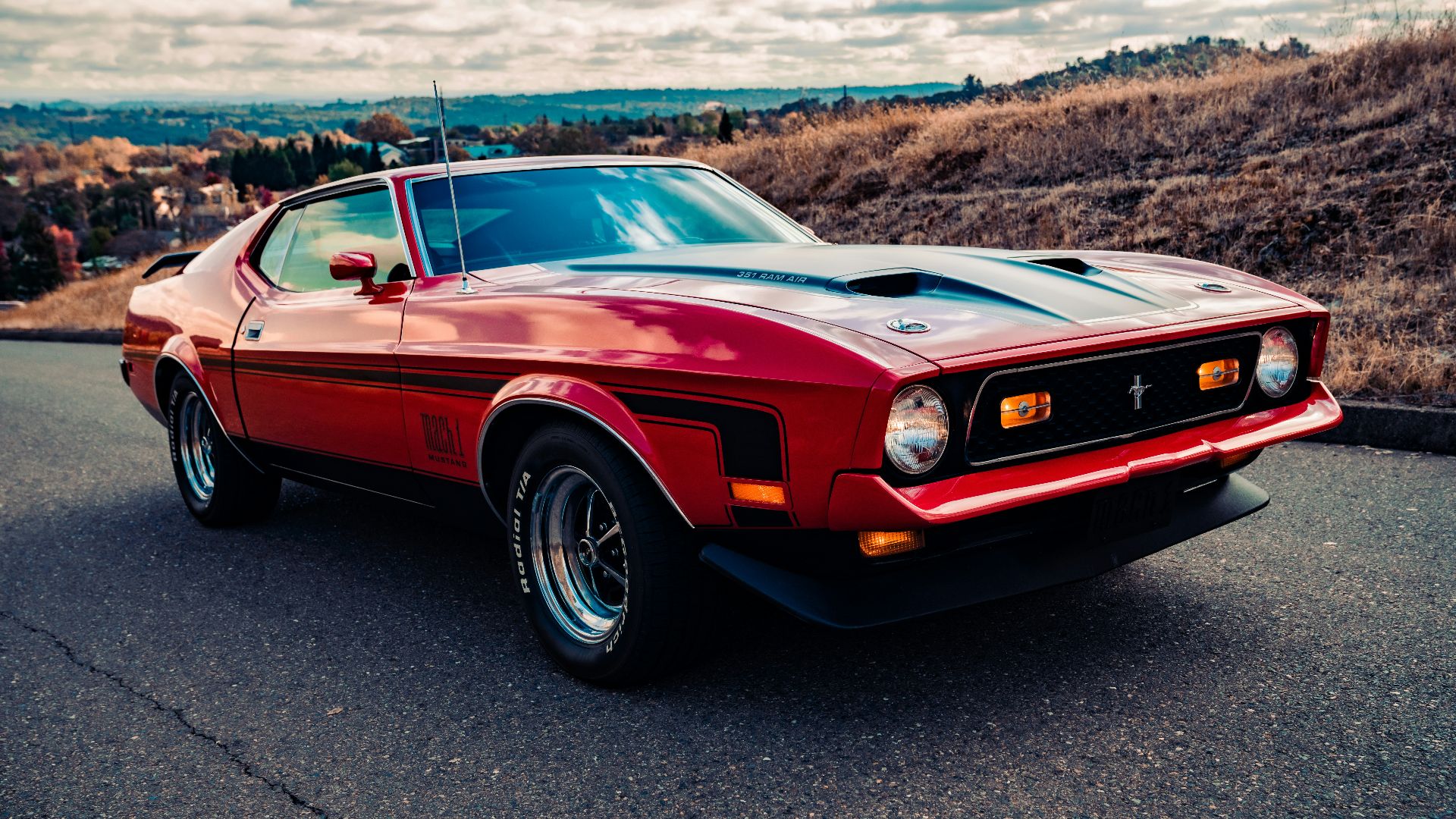 red chevrolet camaro on road during daytime