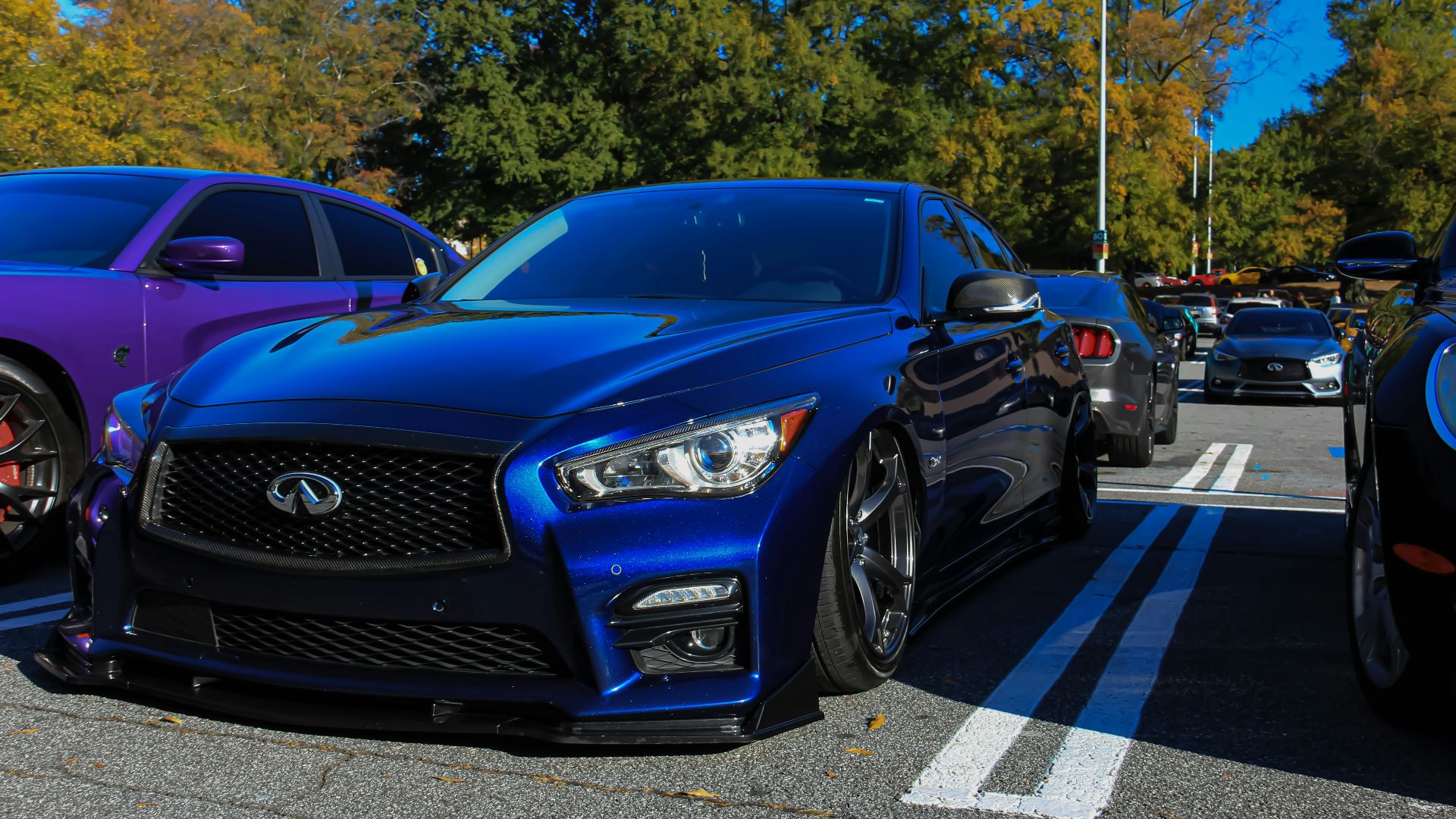a group of cars parked next to each other in a parking lot