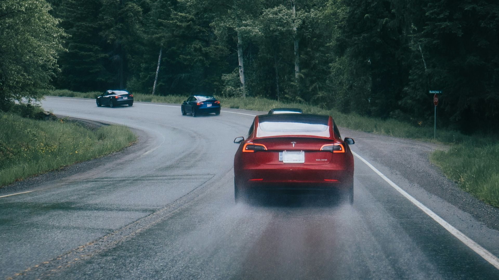 red car on gray asphalt road during daytime
