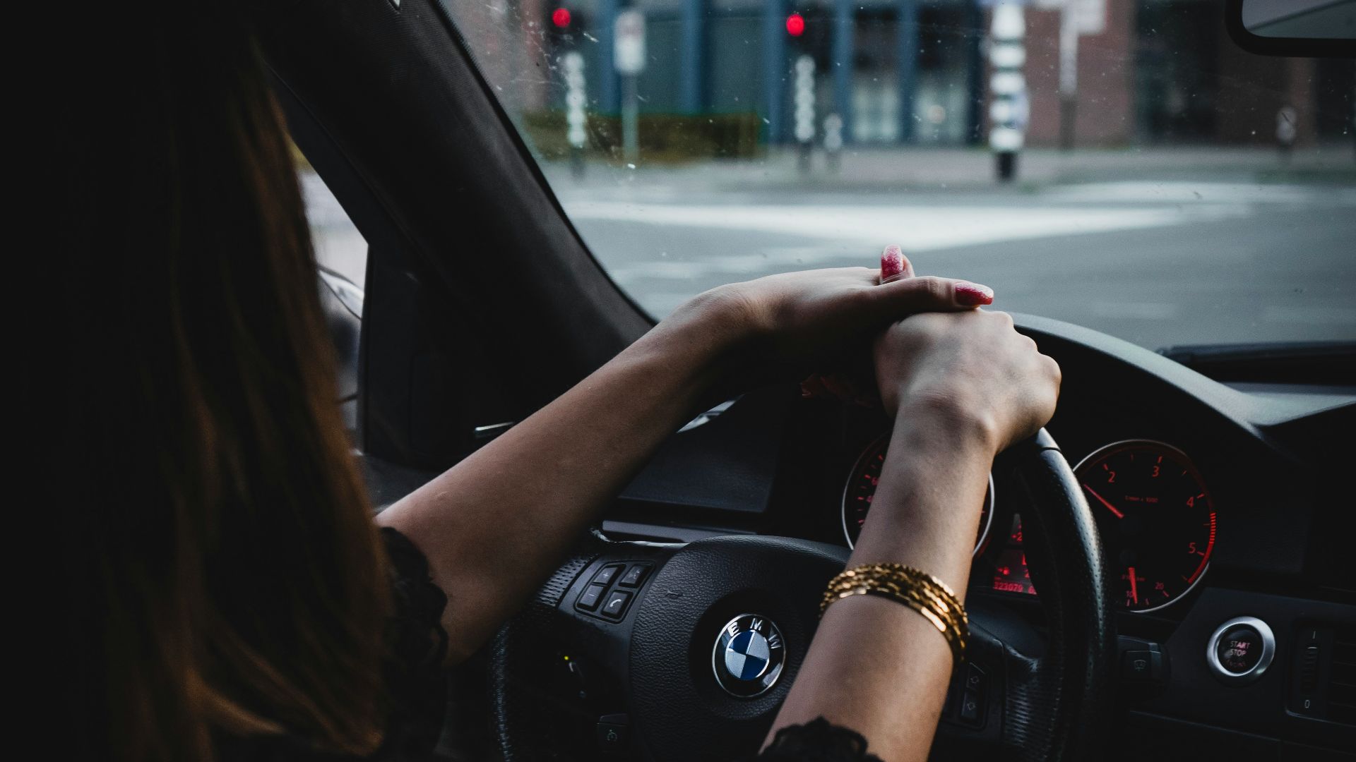 woman inside BMW car holding steering wheel