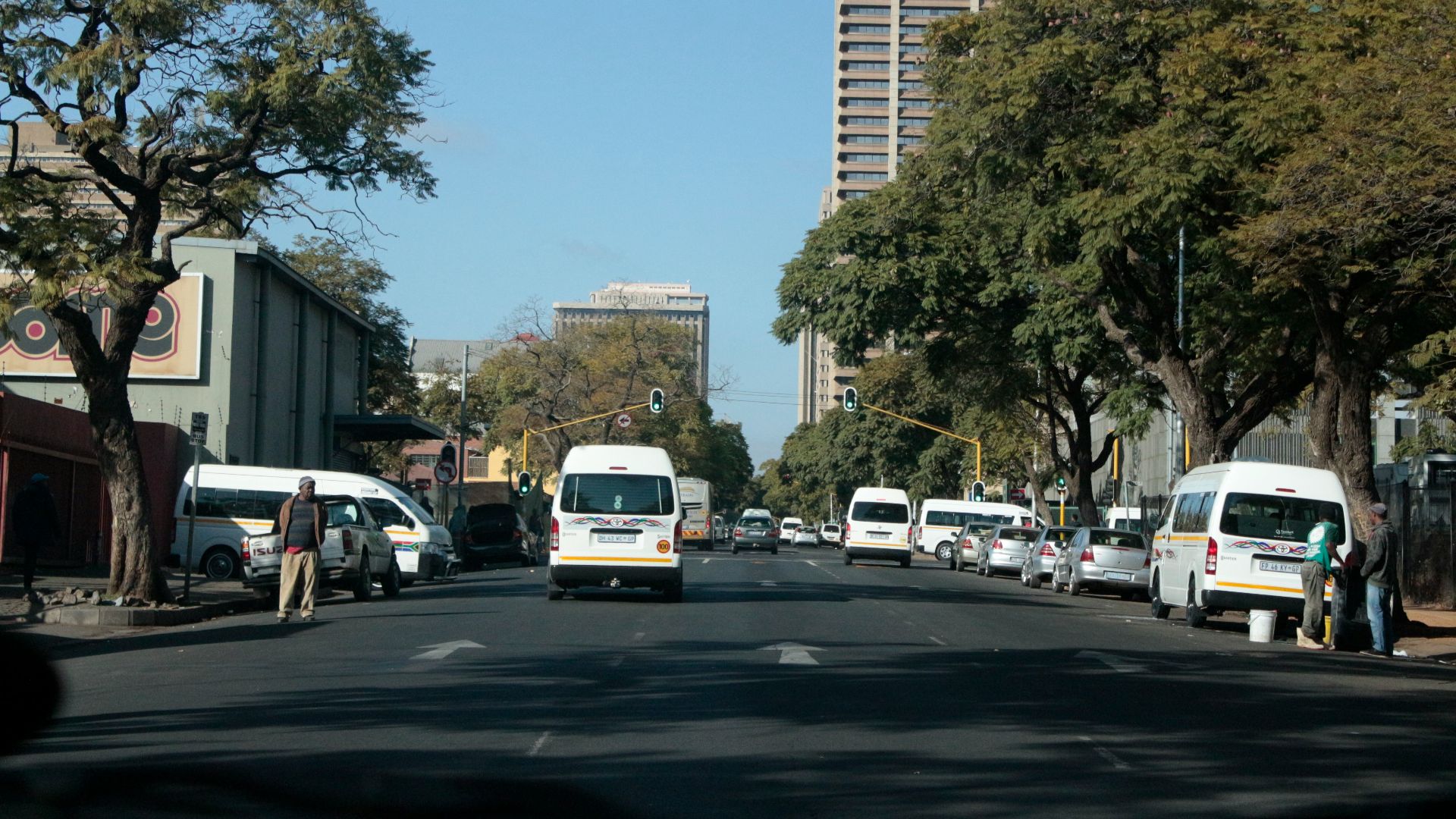 a busy street with cars and people