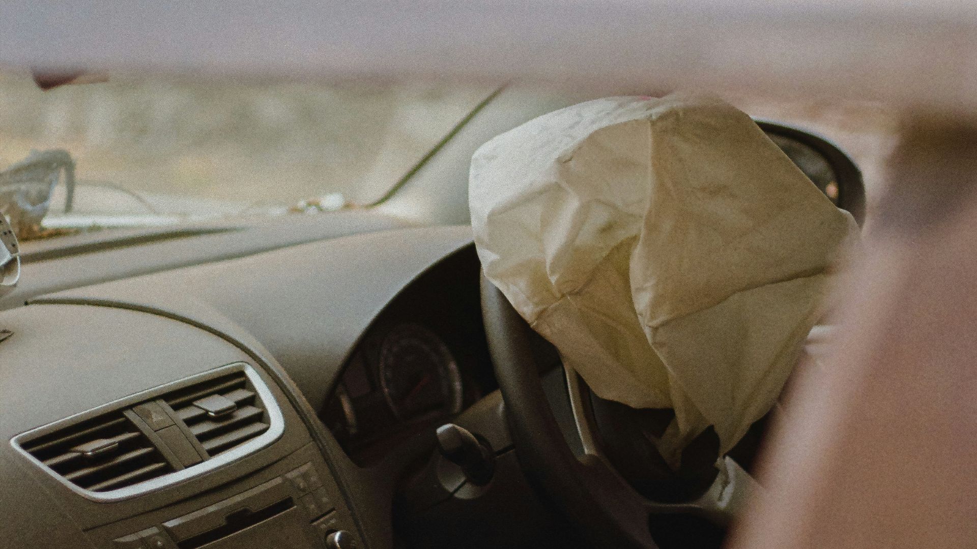 a car with a paper bag in the passenger seat