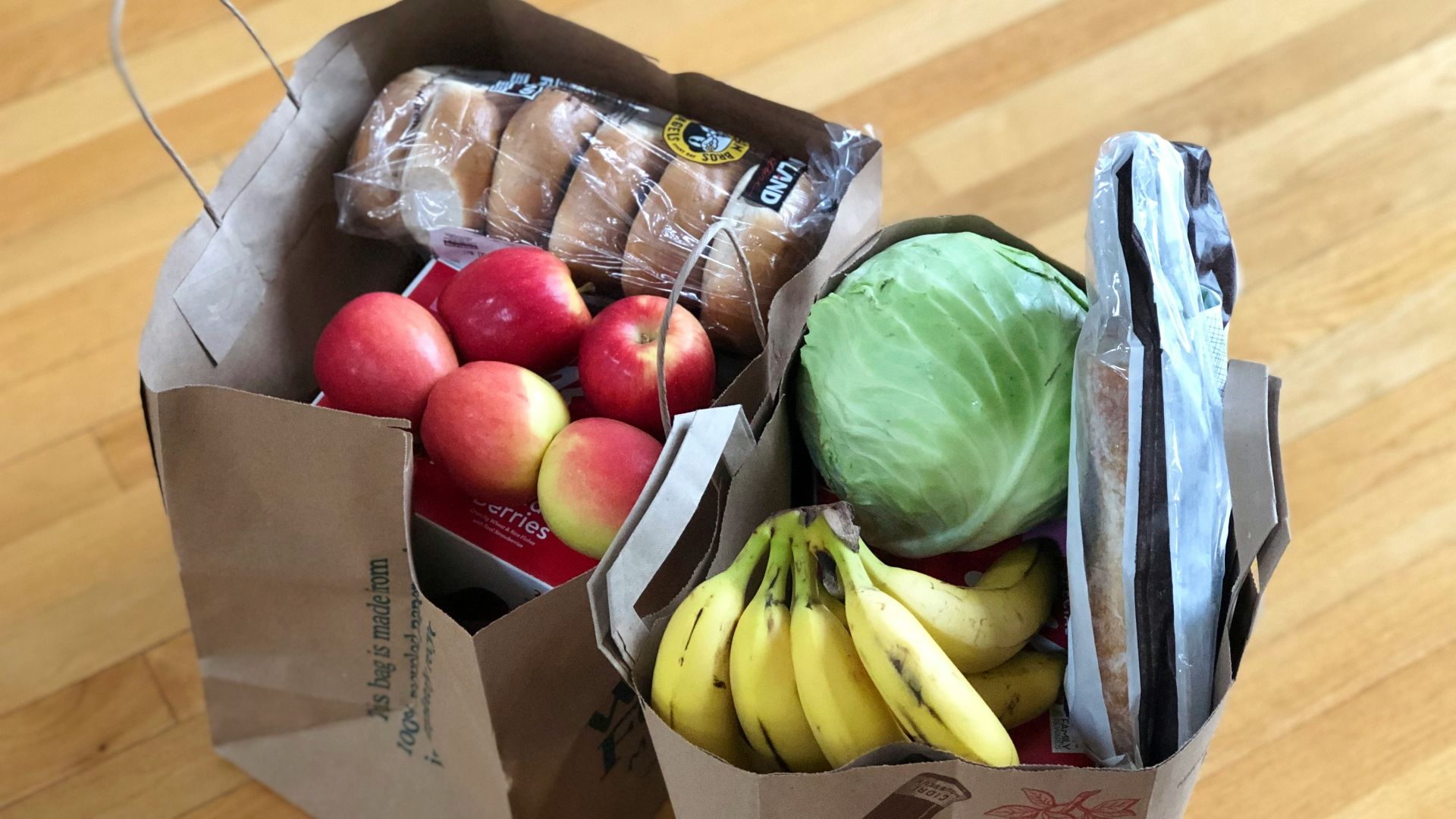 apples and bananas in brown cardboard box