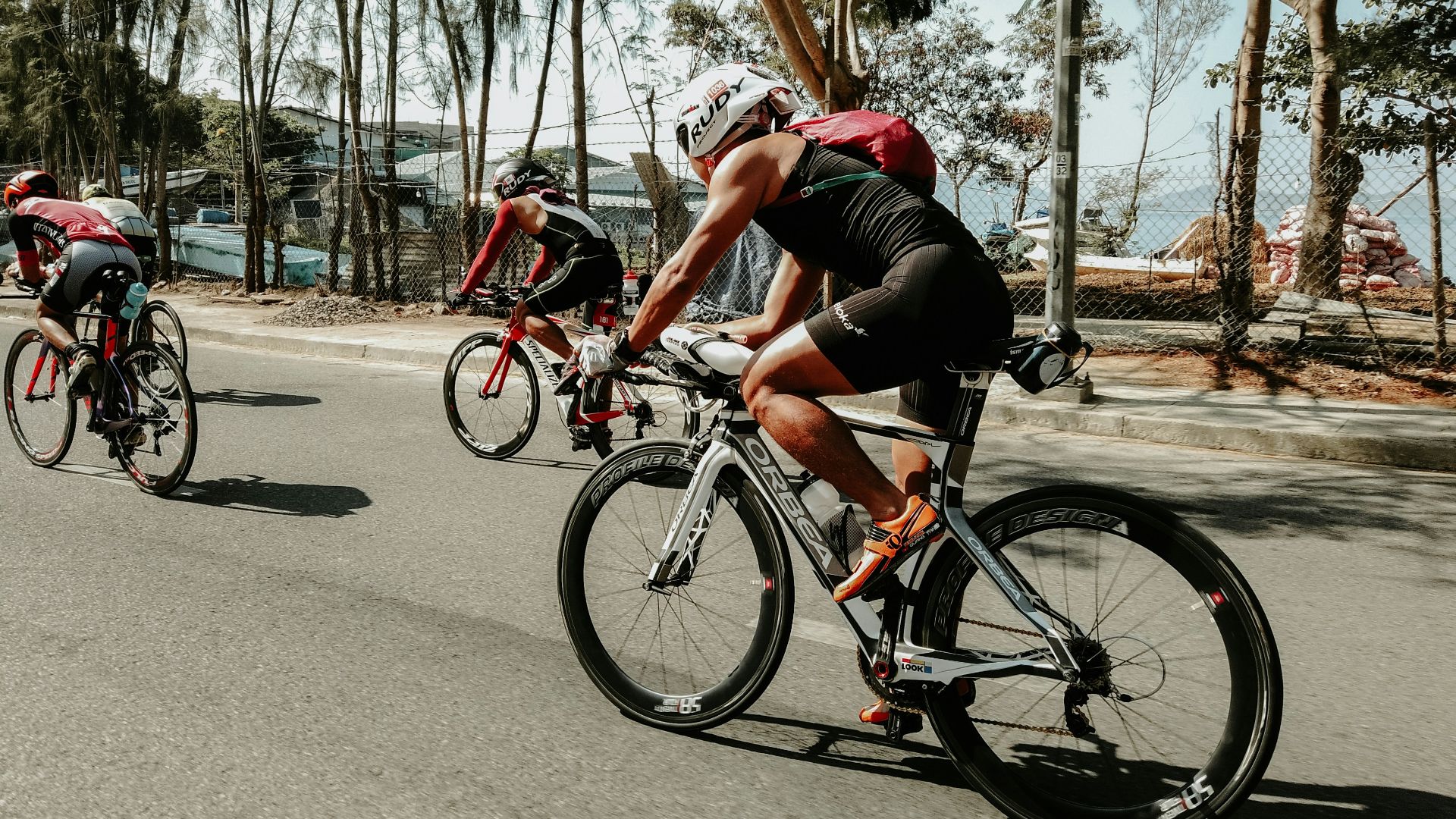 three cyclists on road