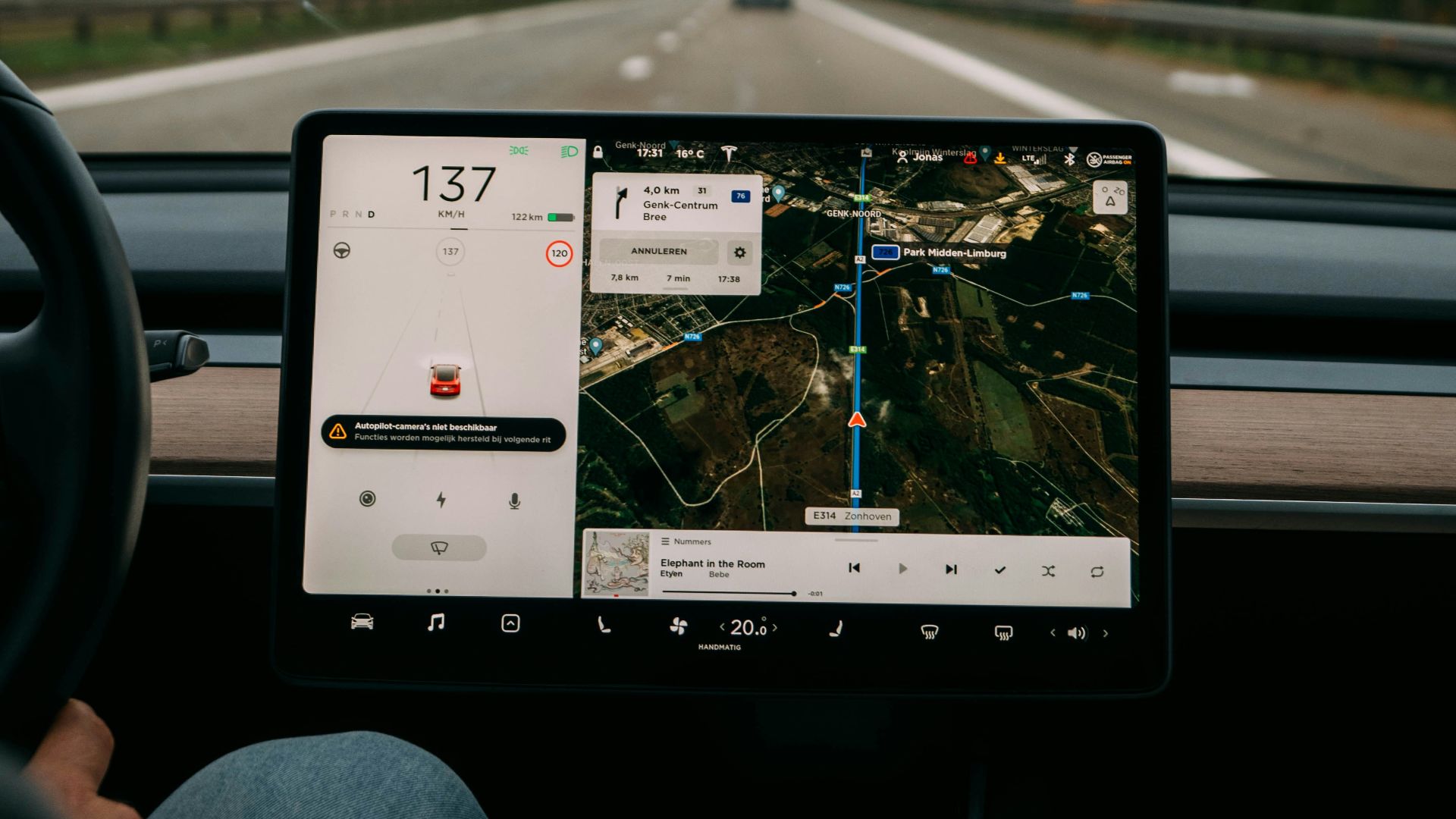 person holding white ipad inside car