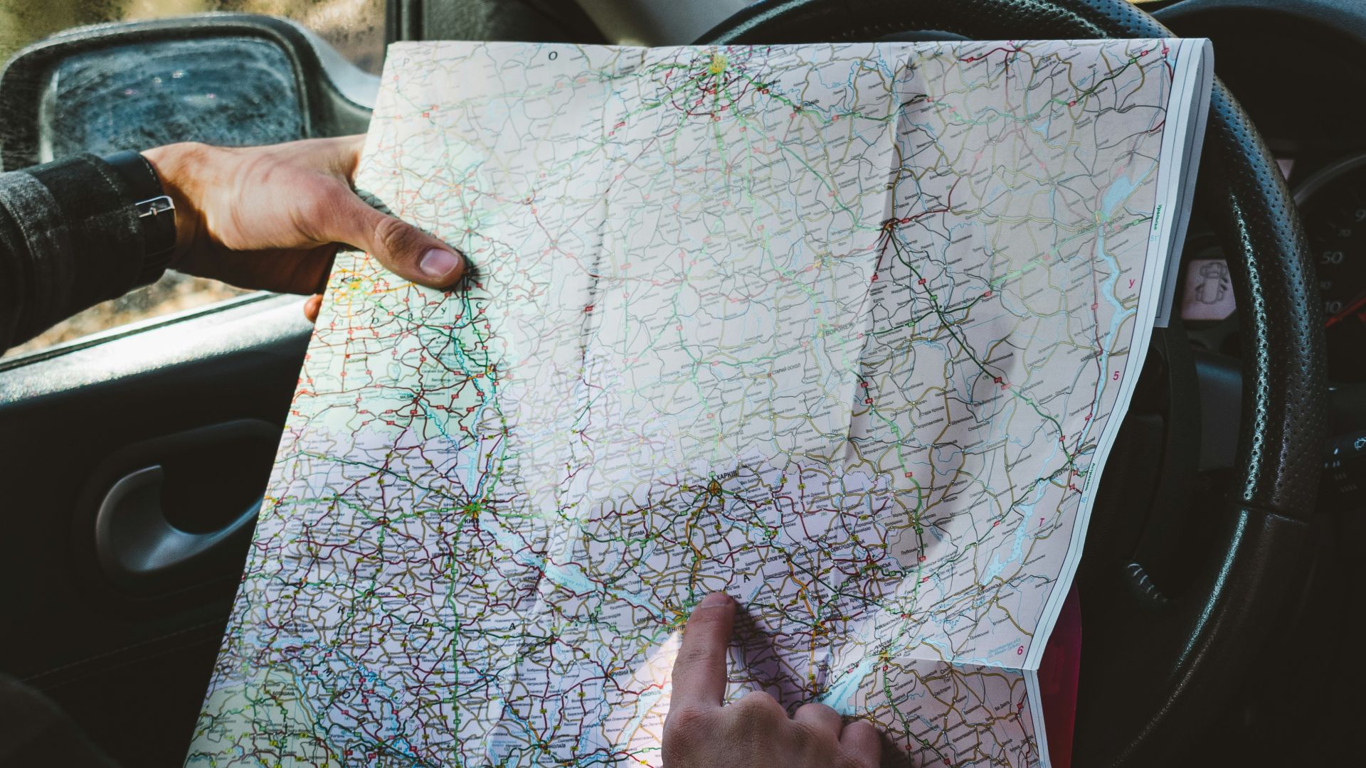 person holding map in vehicle\