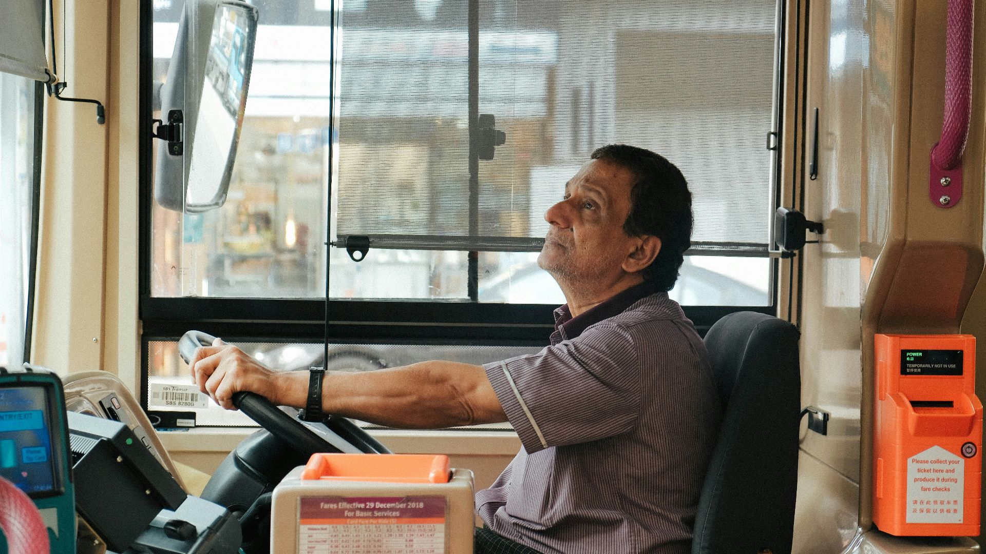 man in brown and white plaid button up shirt sitting on black office rolling chair