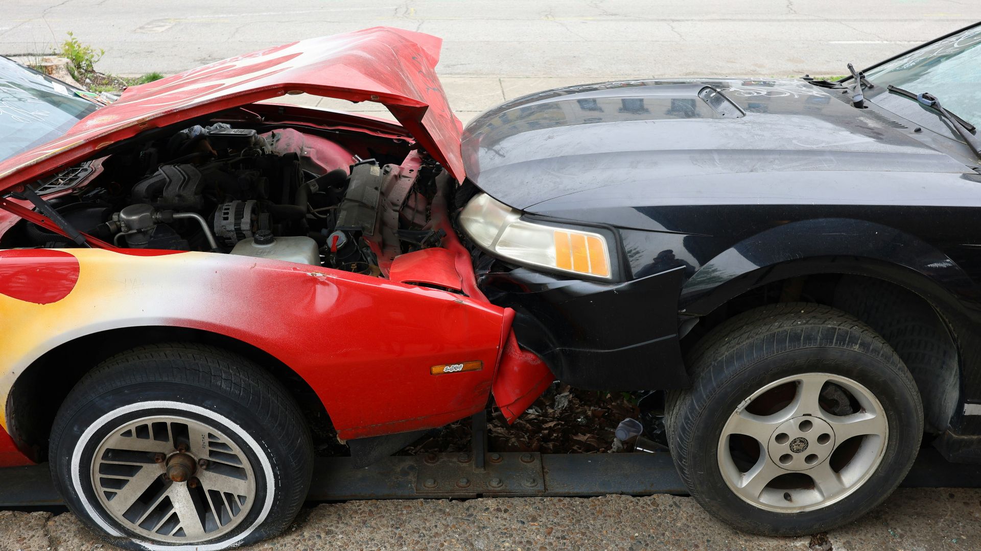 Cars are involved in a frontal collision.