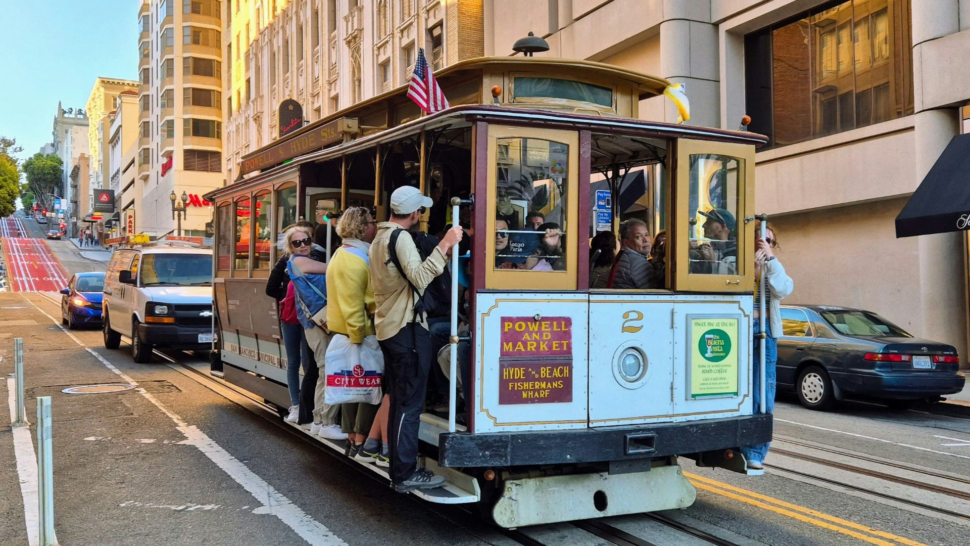 A cable car is traveling down a city street