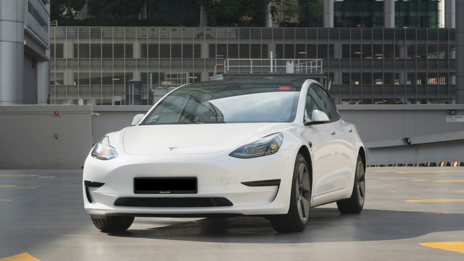 a white car is parked in a parking lot