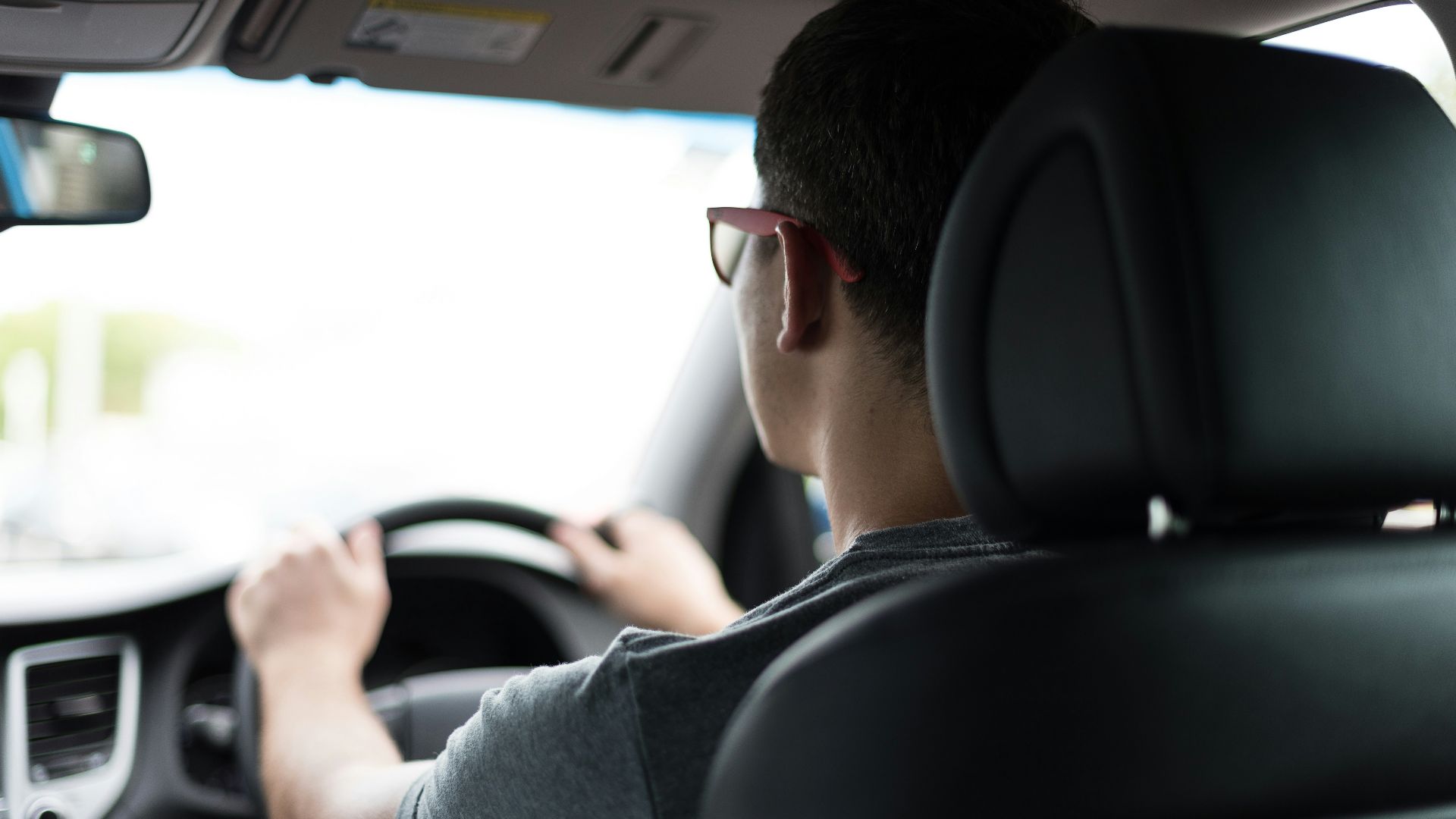 man driving car during daytime