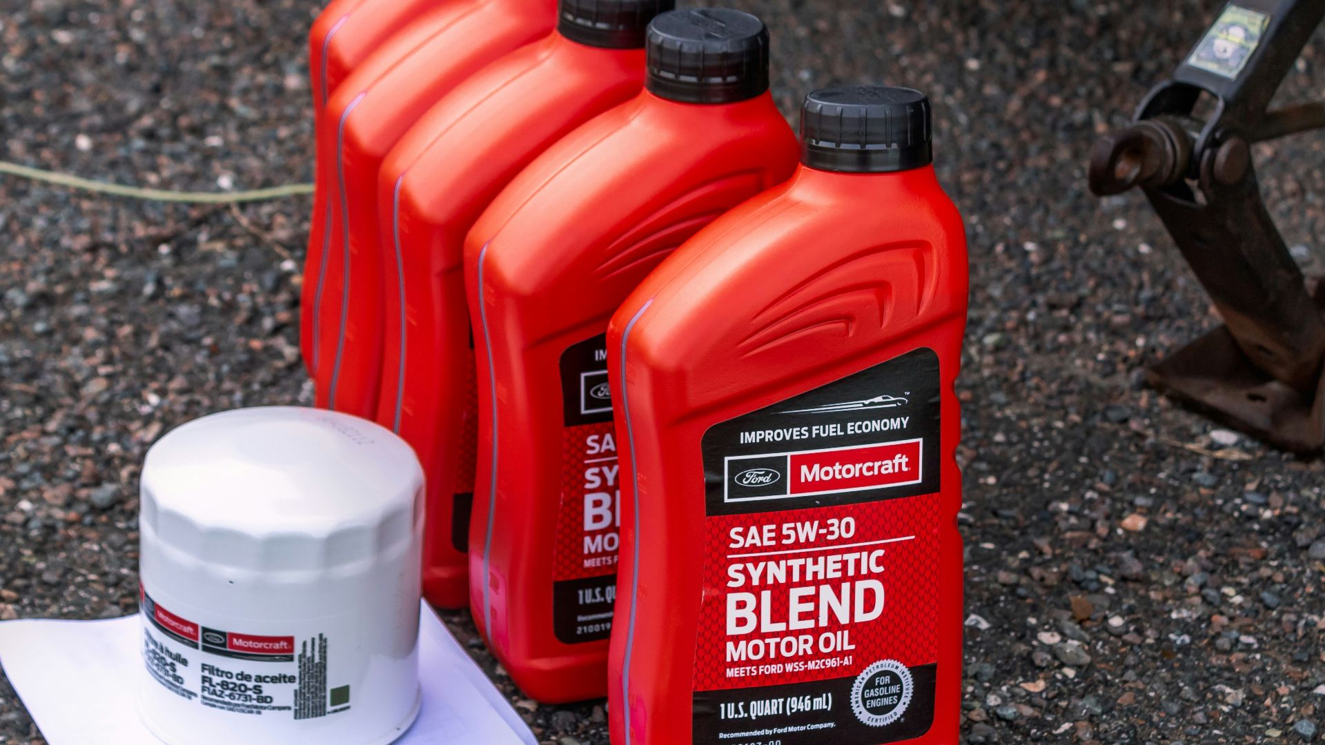 a couple of bottles of motor oil sitting on the ground