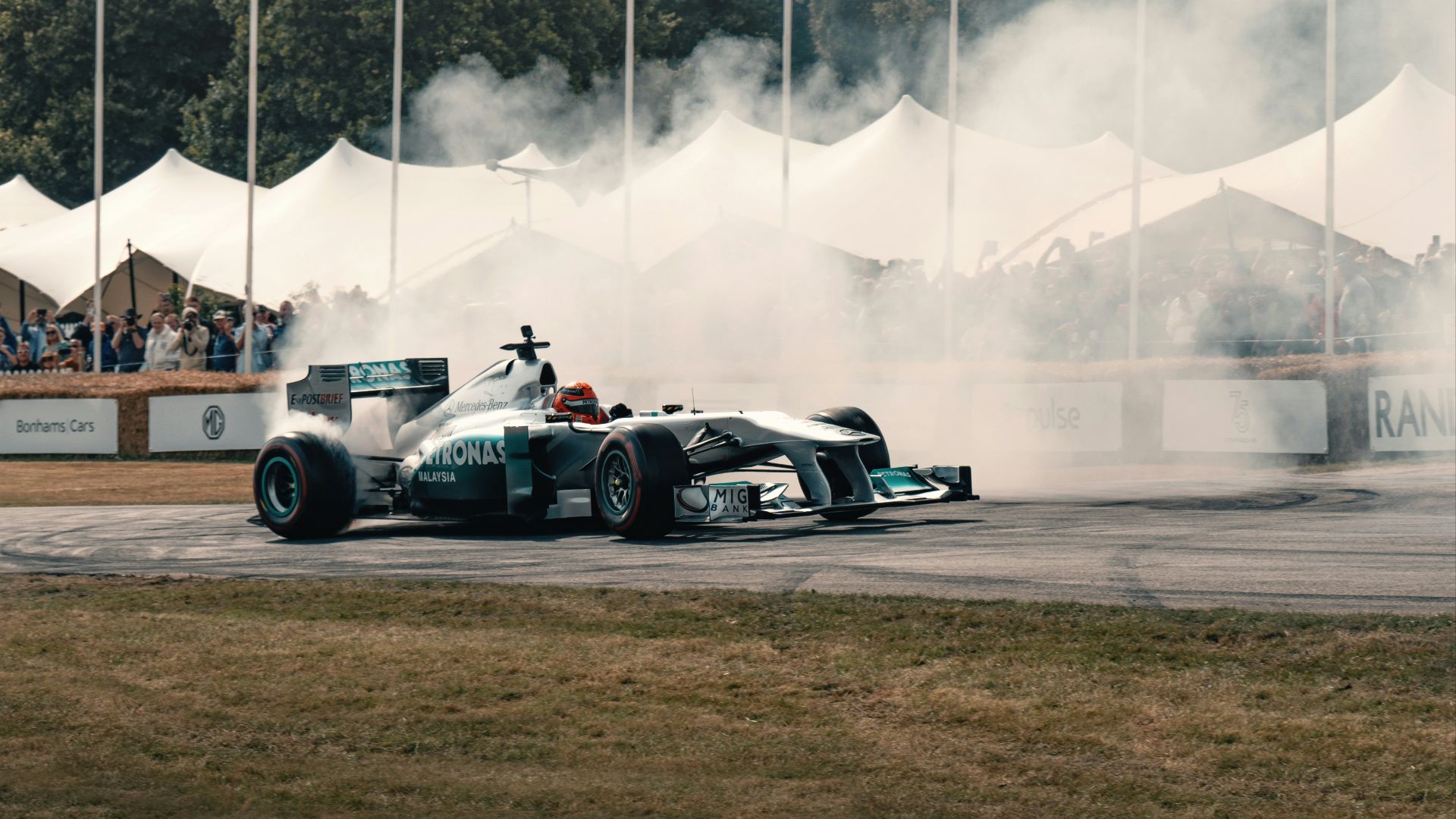 A man driving a race car on top of a race track
