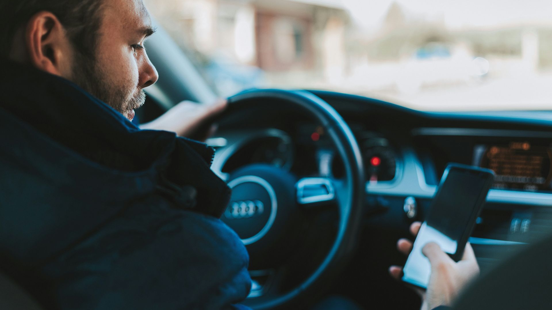 man holding black smartphone