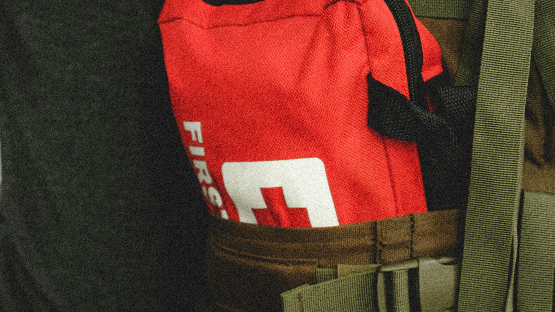 man in red and black shirt and brown pants with black backpack