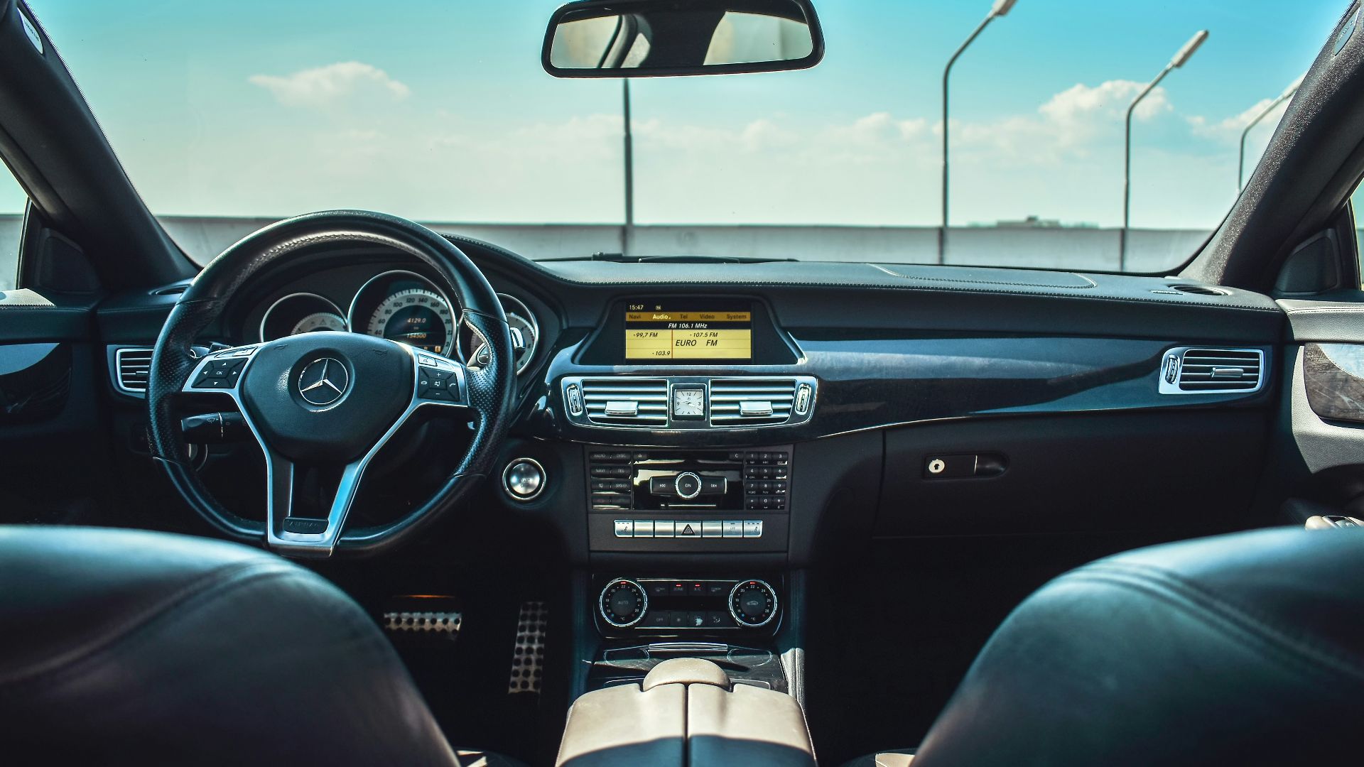 black Mercedes-Benz vehicle steering wheel