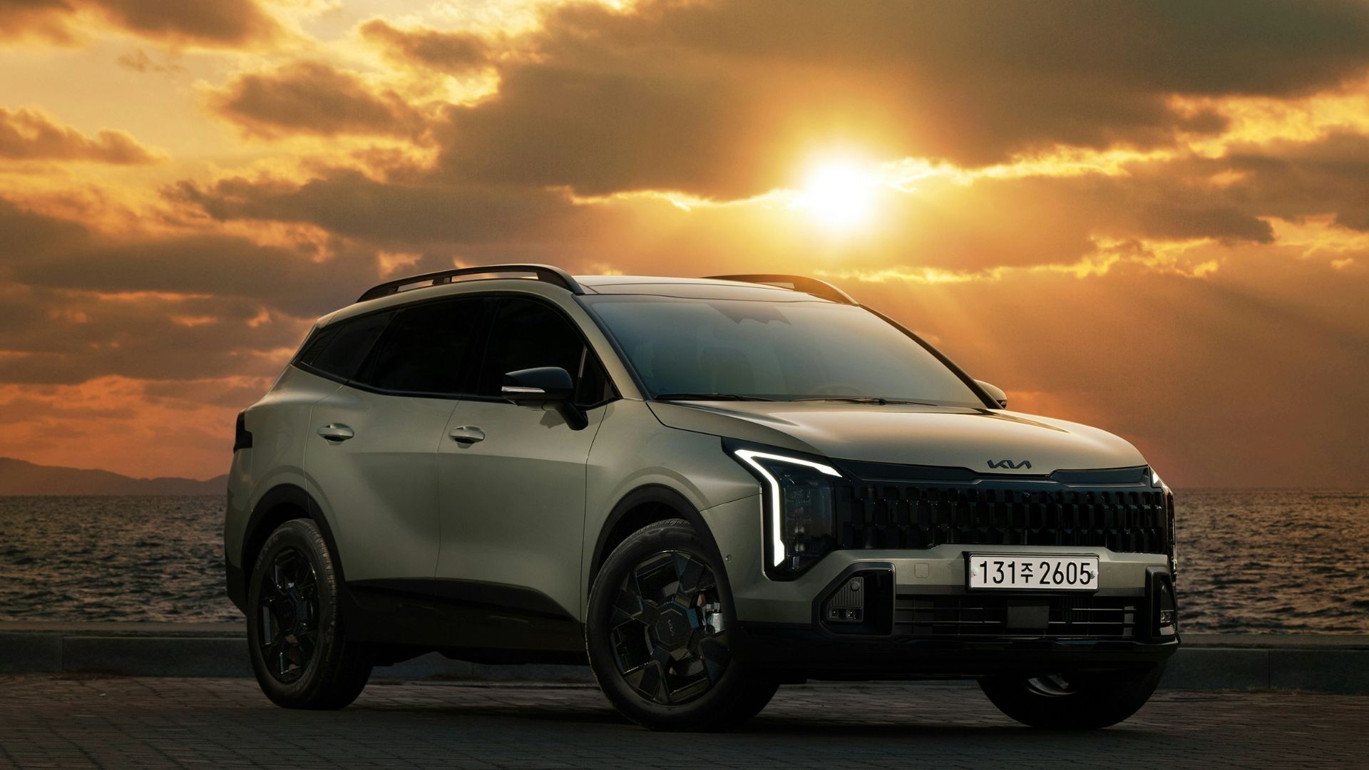 A car parked on a brick road near the ocean