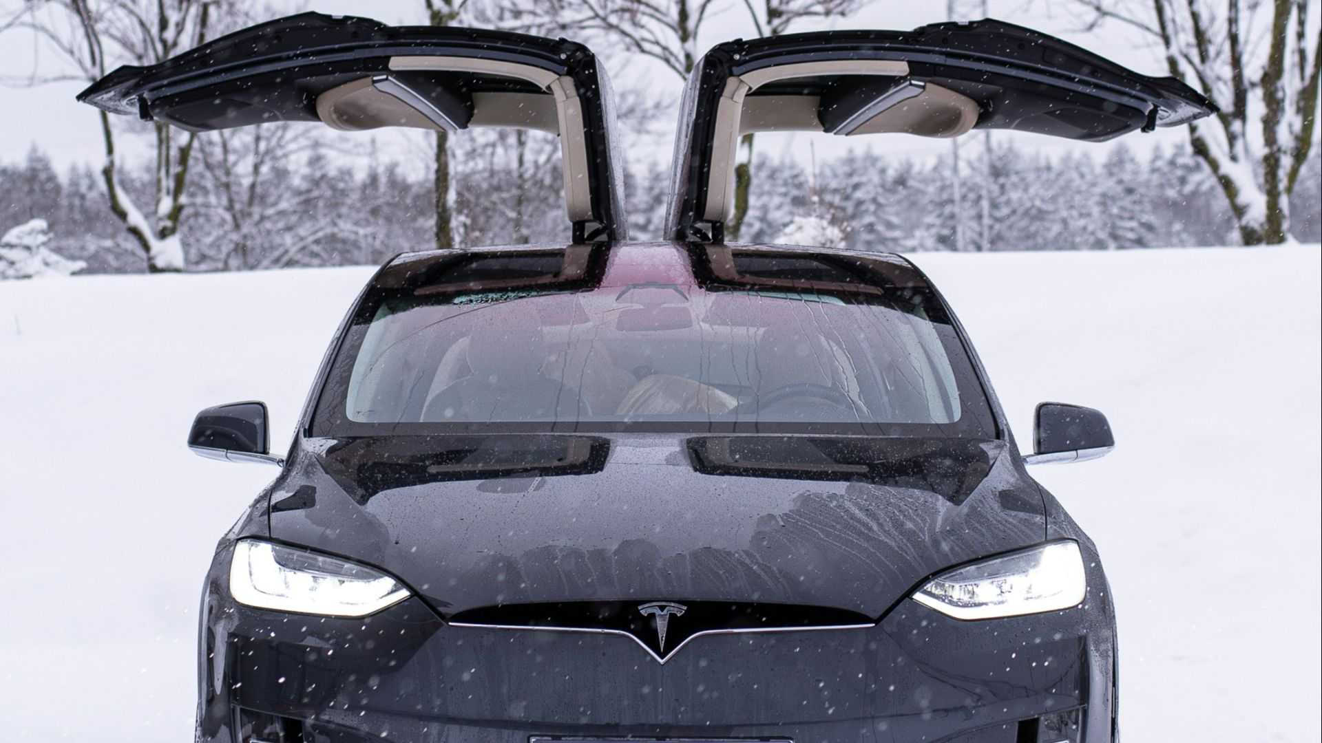 a black car parked in the snow