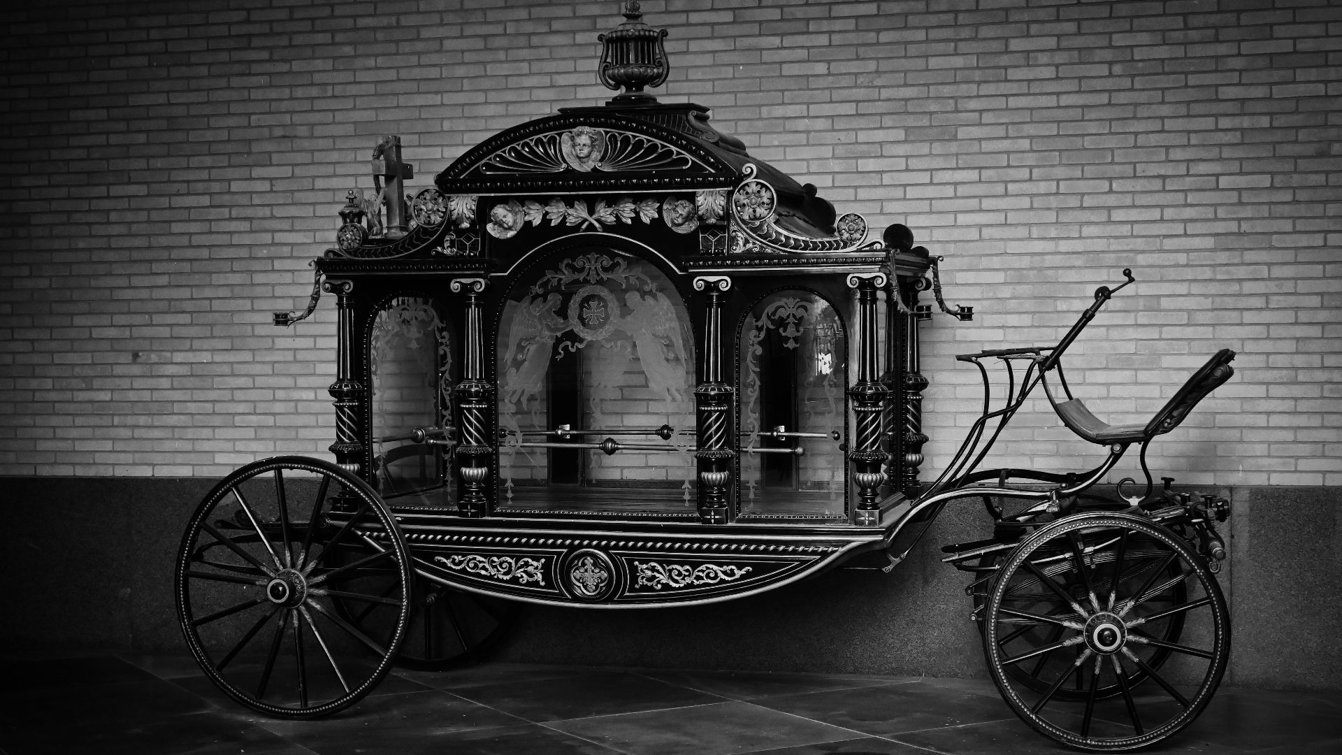 A black and white photo of a horse drawn carriage