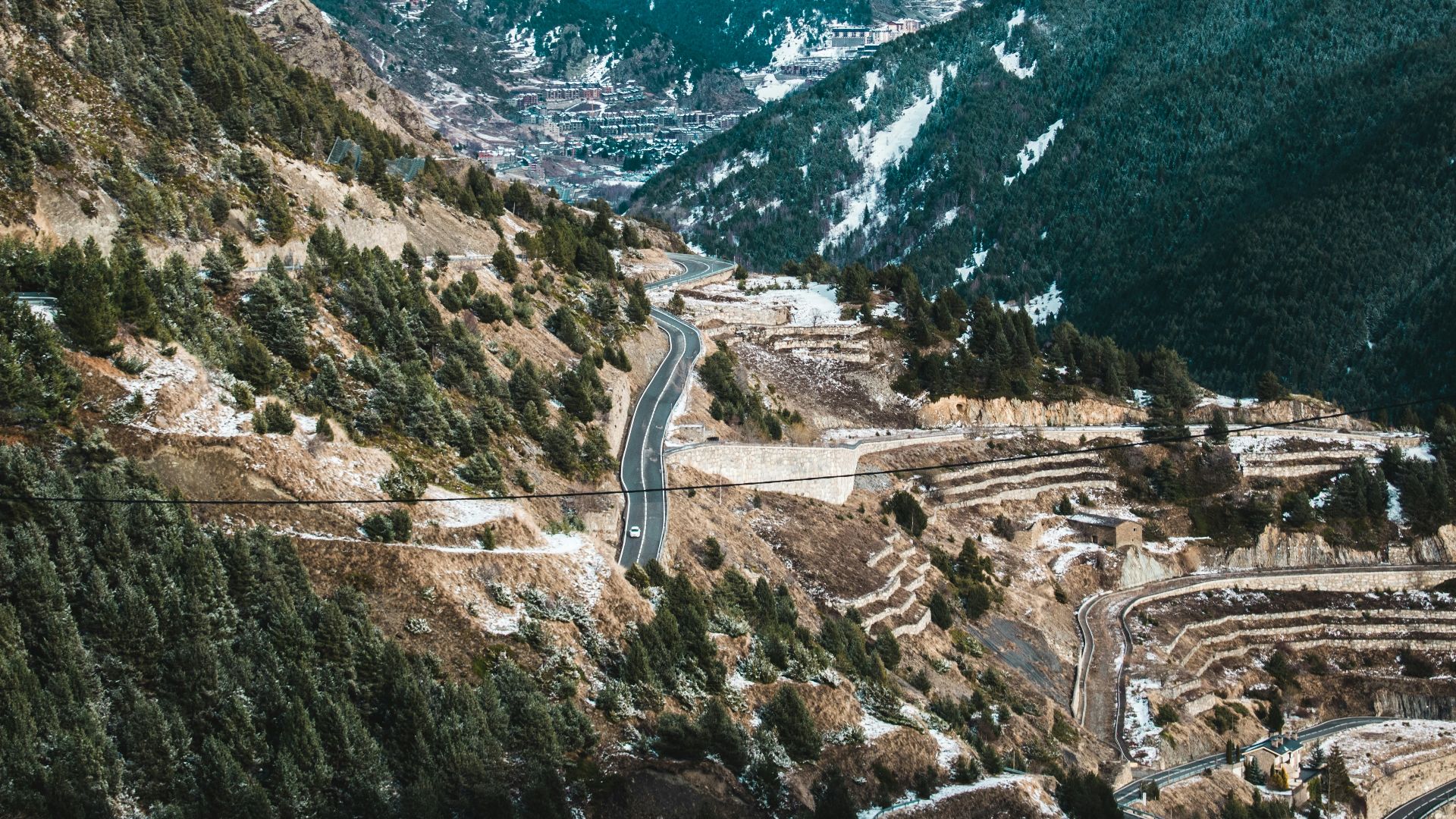 a scenic view of a winding road in the mountains