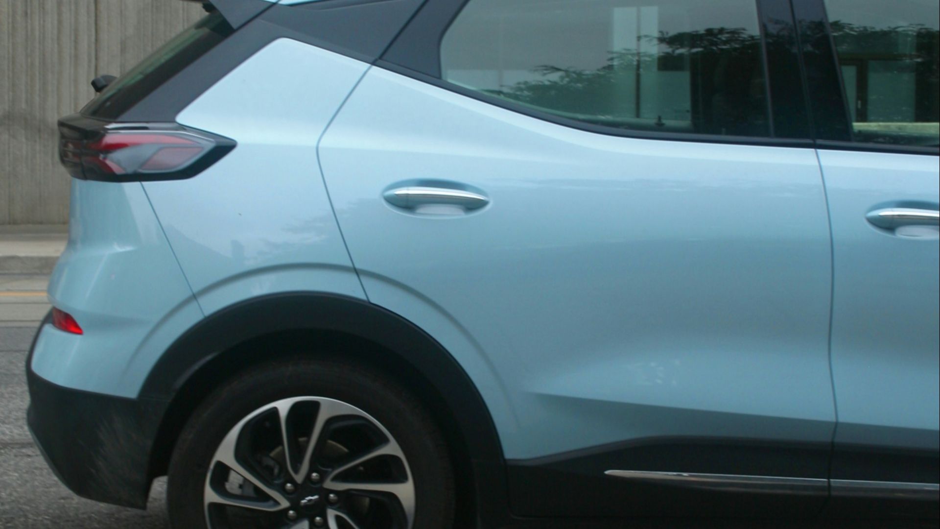 a blue car parked on the side of the road