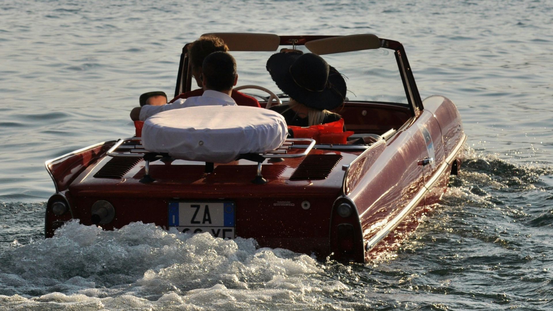 red convertible car on water during daytime