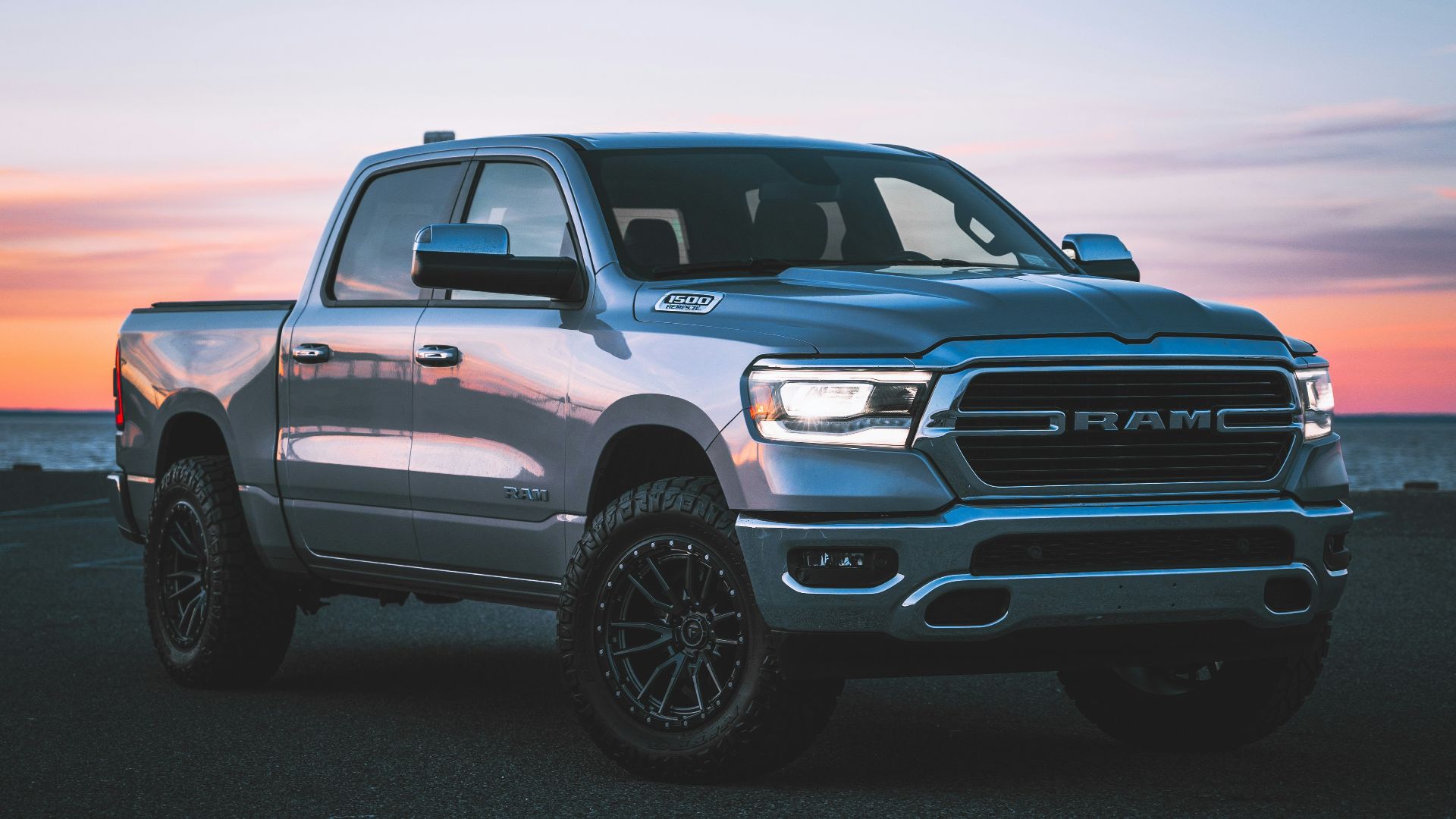a silver ram truck parked in a parking lot