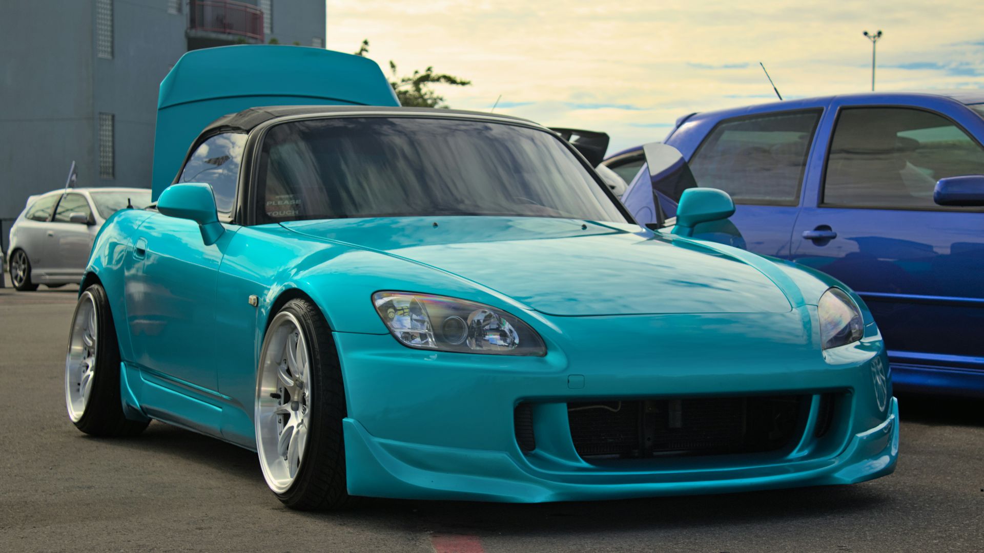 a blue sports car parked in a parking lot