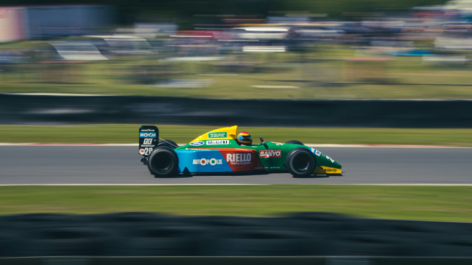 blue and yellow f 1 car on road