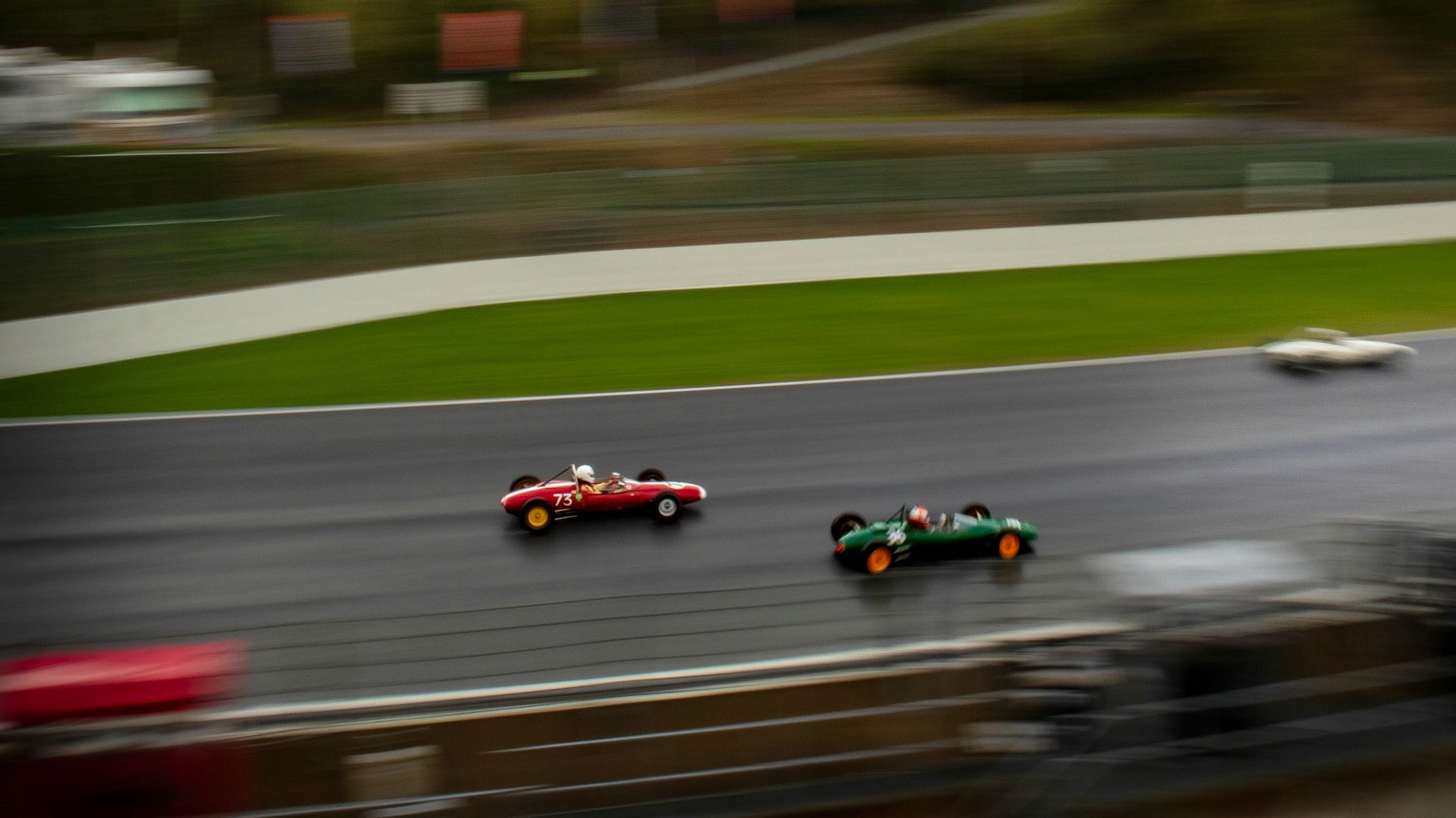 A blurry photo of a race track with cars on it
