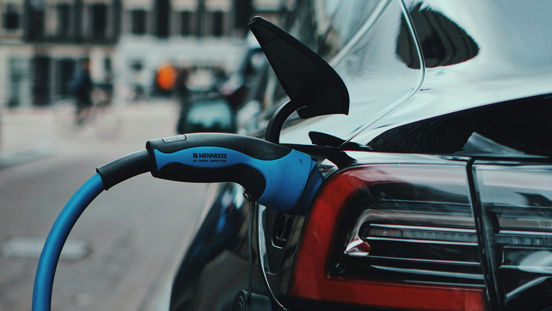 white and black car in front of white building during daytime