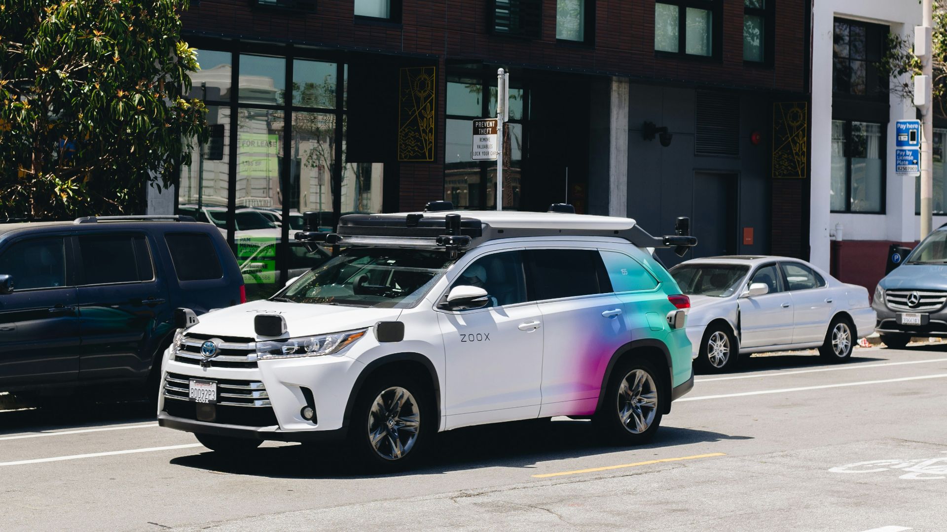 a multicolored car parked on the side of the road