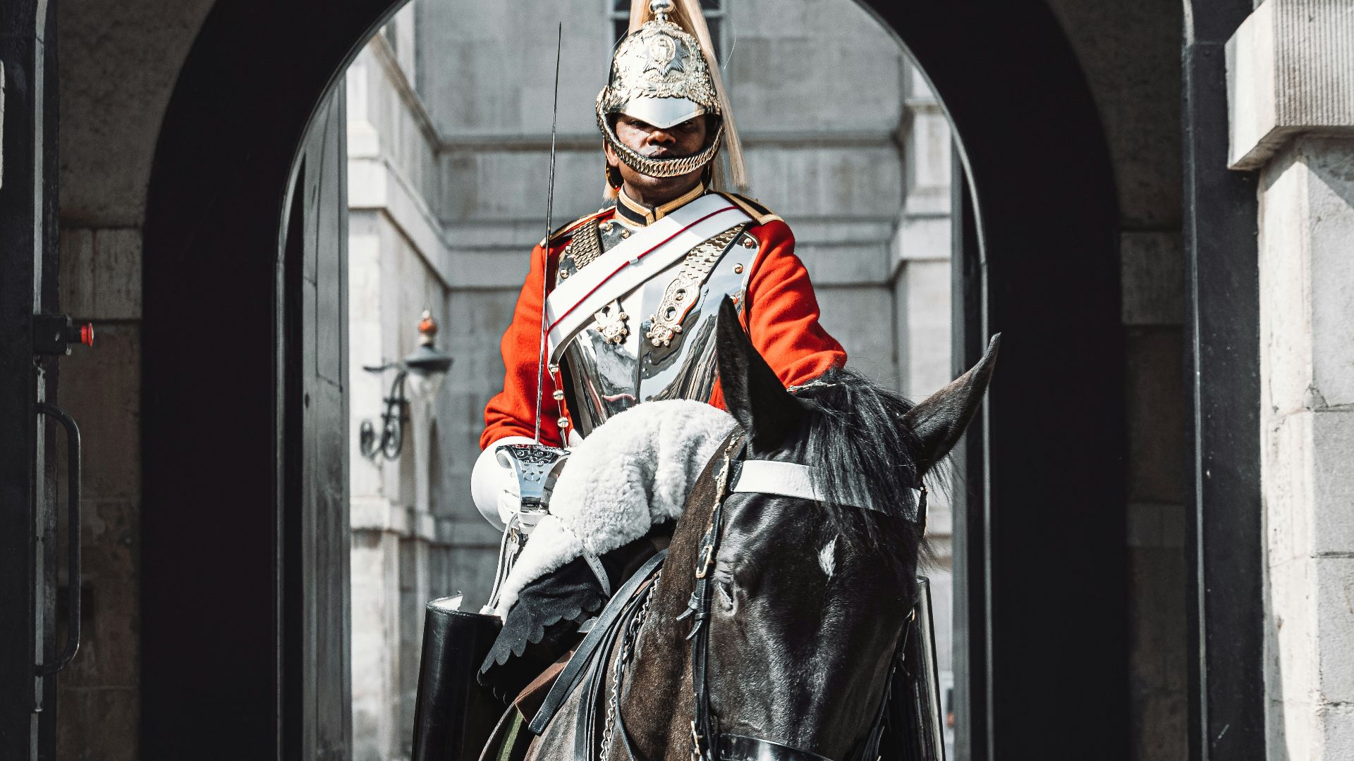 a man riding on the back of a brown horse