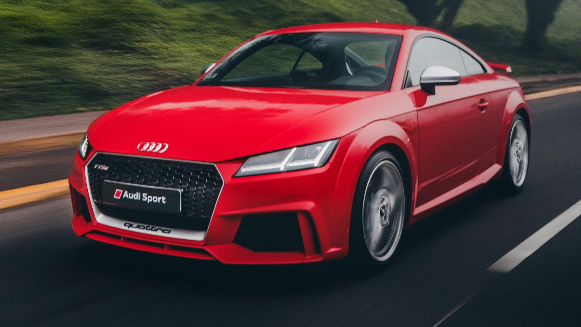 red Audi coupe on road near trees at daytime