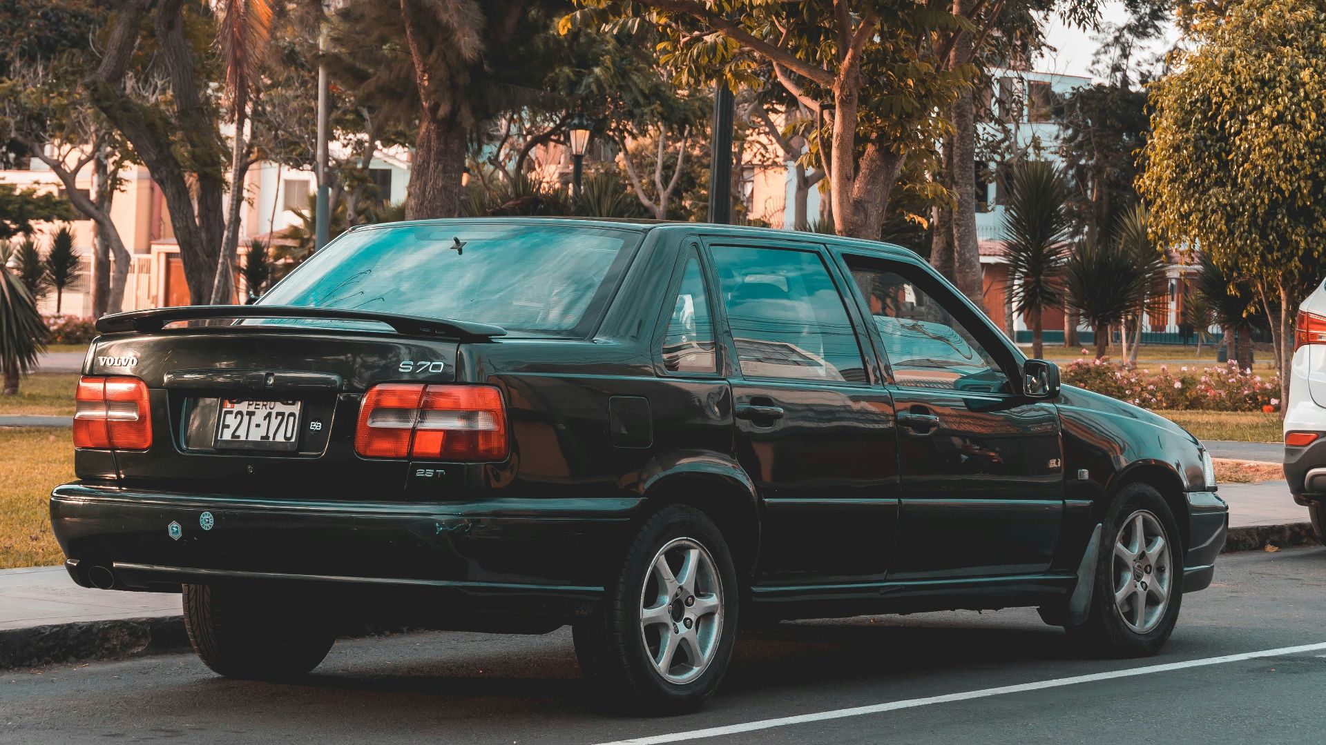 a black car parked on the side of the road