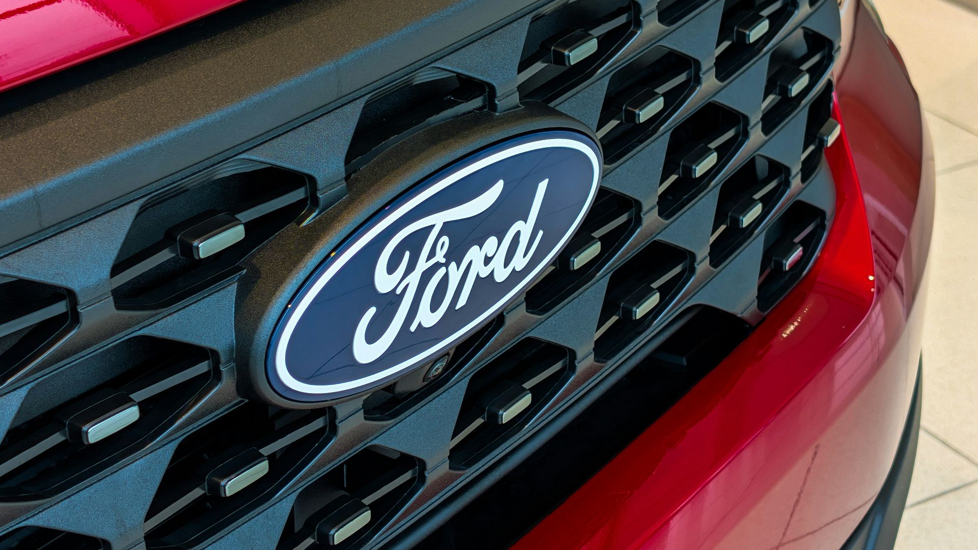 Close-up of a red ford car grille