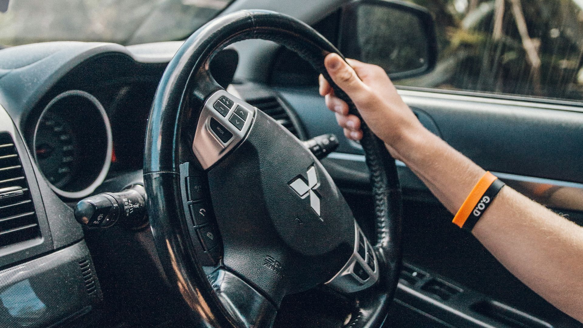 person holding black steering wheel